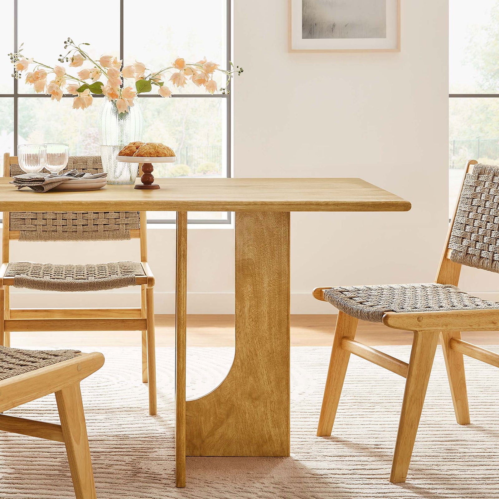Oak dining table styled in a bright dining room with woven chairs and decor || EEI-6593-OAK || detail_room