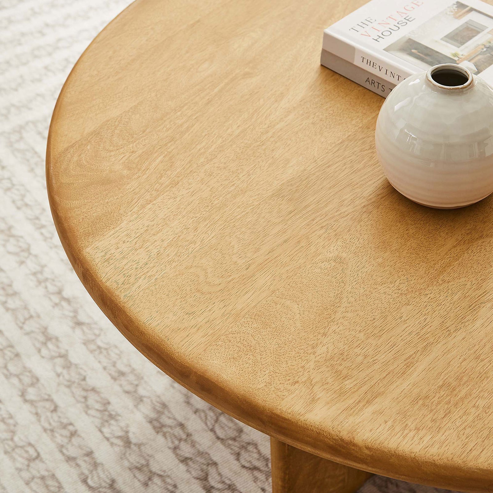 Warm mango wood tabletop offers a smooth surface for books and decor in a cozy living space. || EEI-6594-OAK || detail_room