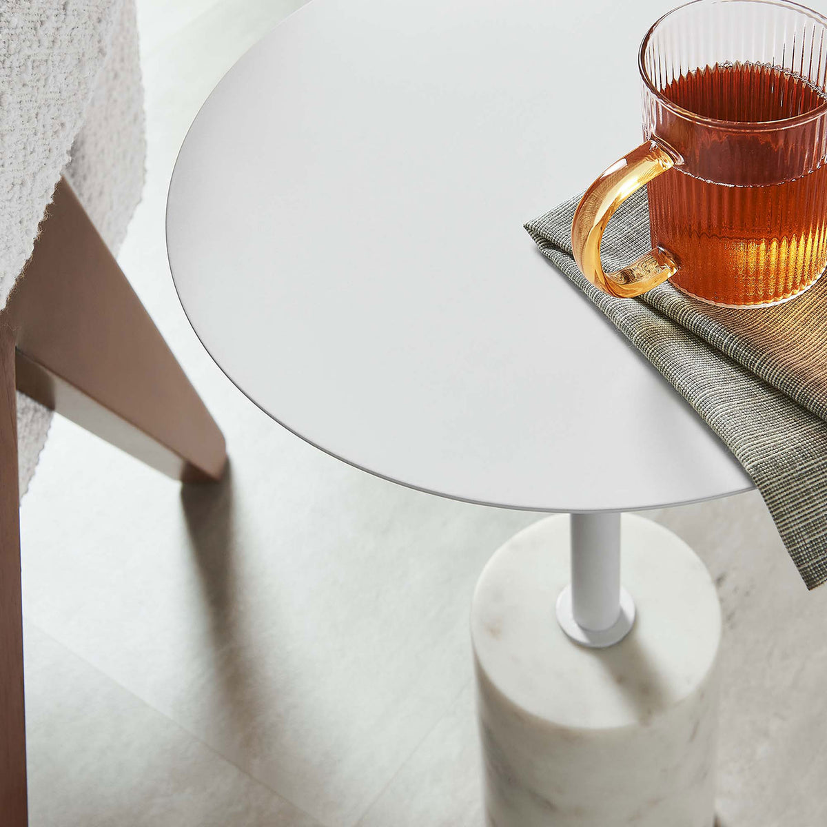 Lyric side table brings airy modern style beside a cozy chair, perfect for holding a warm drink and essentials. || EEI-6605-WHI-WHI || top_angle_room