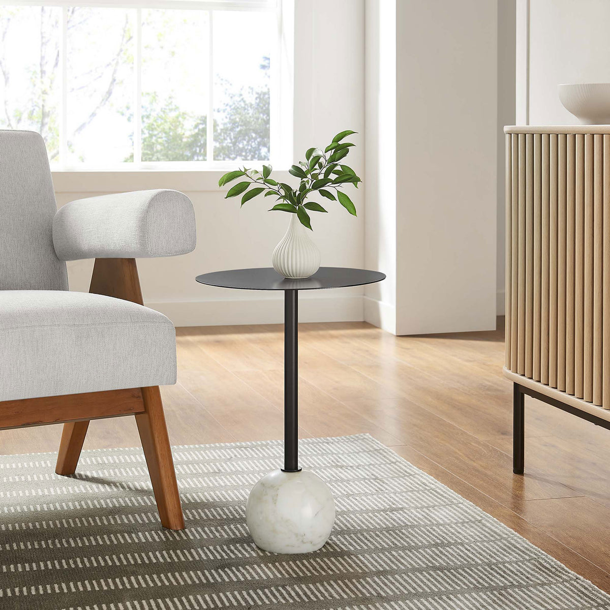 Aliza side table with black top and white marble base adds modern charm to a bright living space || EEI-6606-WHI-BLK || front_angle_room