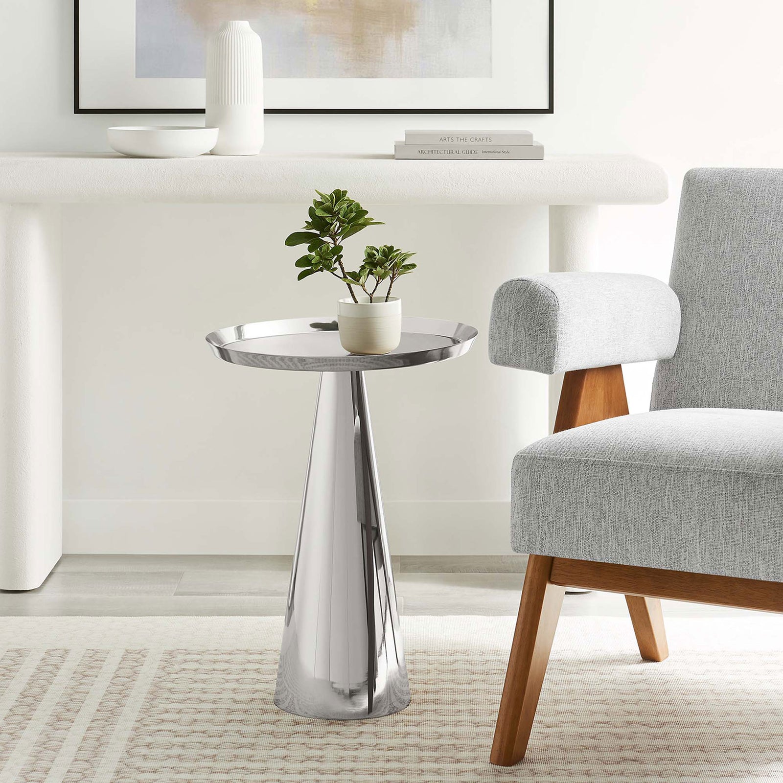 Maren round side table in a modern living room next to an upholstered chair || EEI-6608-NIC || front_angle_room