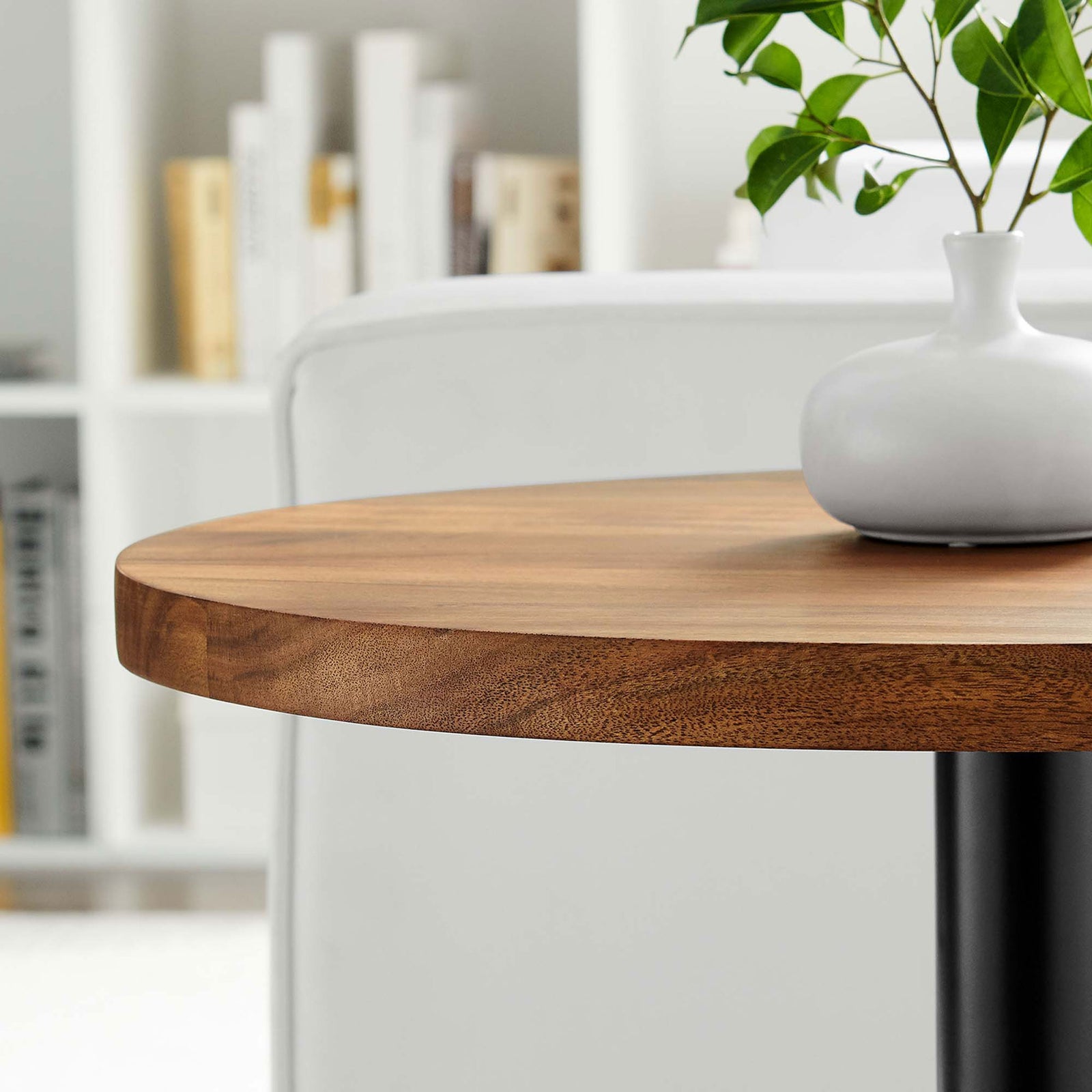 Viva side table beside sofa styled with vase to showcase warm acacia top in modern room || EEI-6610-BLK-LOC || detail_room
