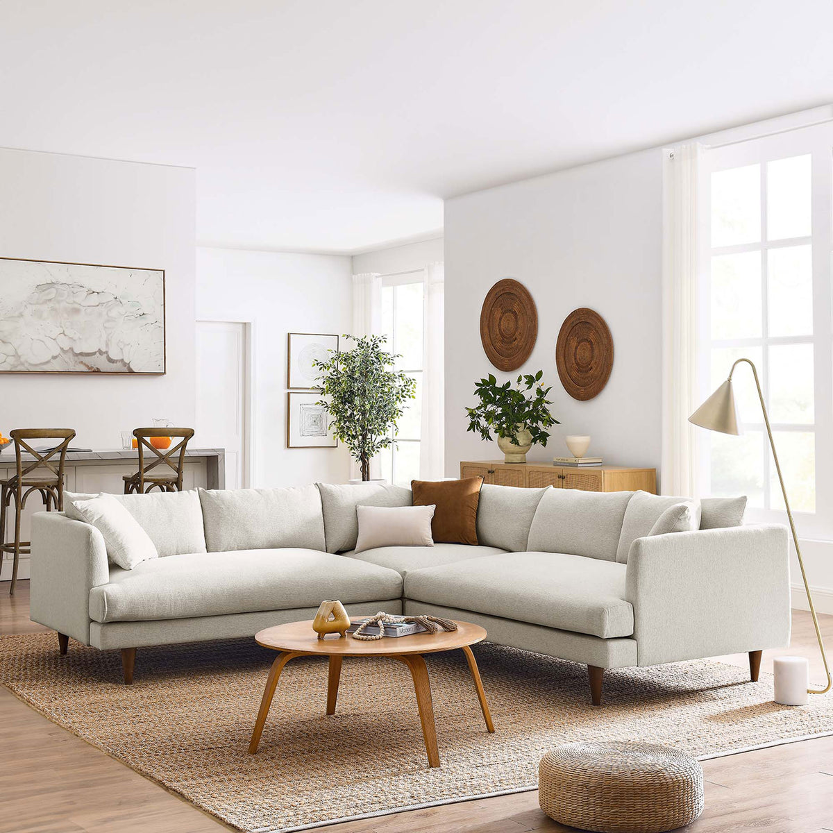 Ivory sectional sofa anchored in a bright living room with wood accents, floor lamp, and woven area rug || EEI-6613-HEI || front_angle_room