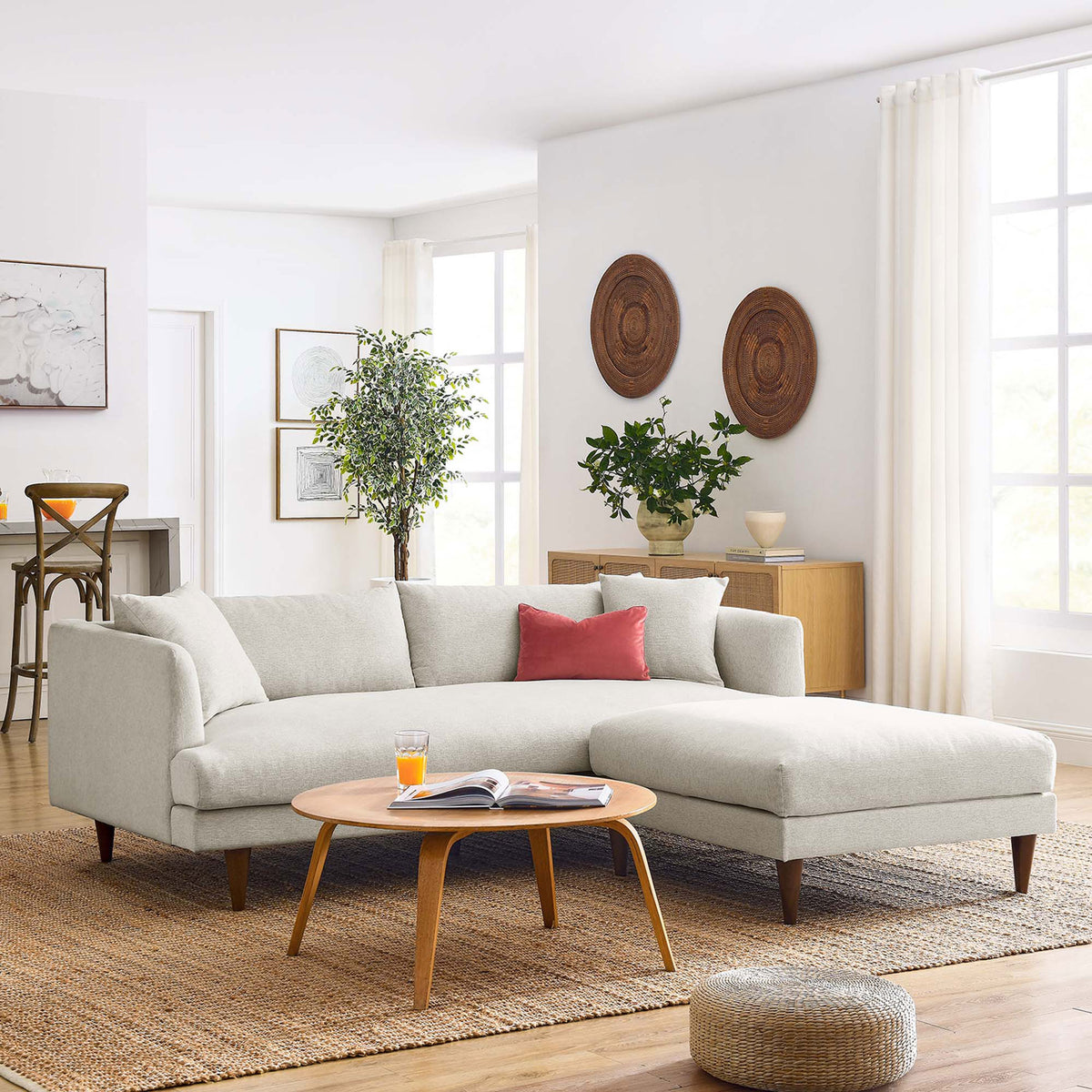 Spacious ivory sofa and ottoman set arranged for family lounging in a light-filled contemporary room || EEI-6614-HEI || front_angle_room