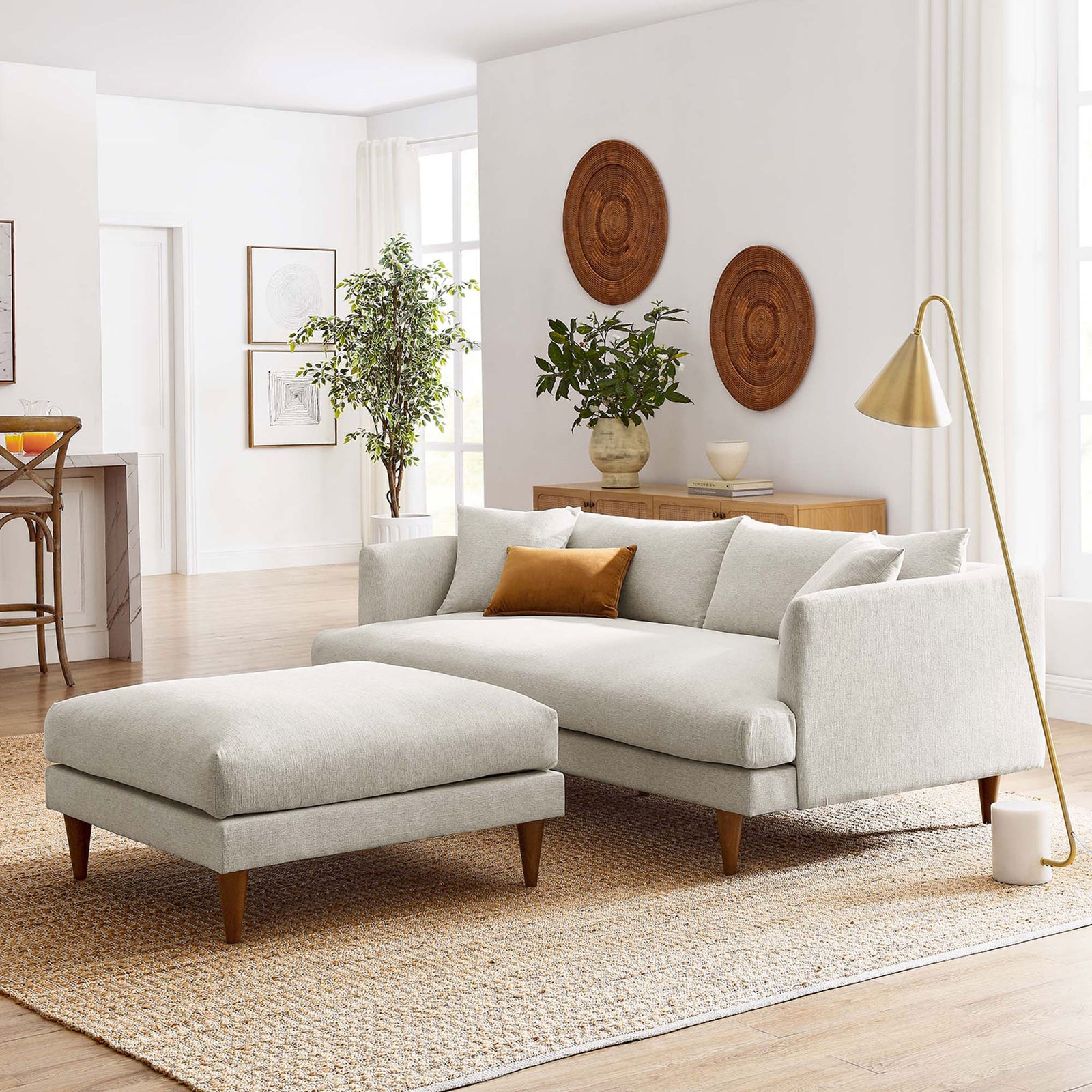 Ivory down-filled sofa and ottoman set creating a cozy focal point in a bright modern living room || EEI-6614-HEI || front_angle_room