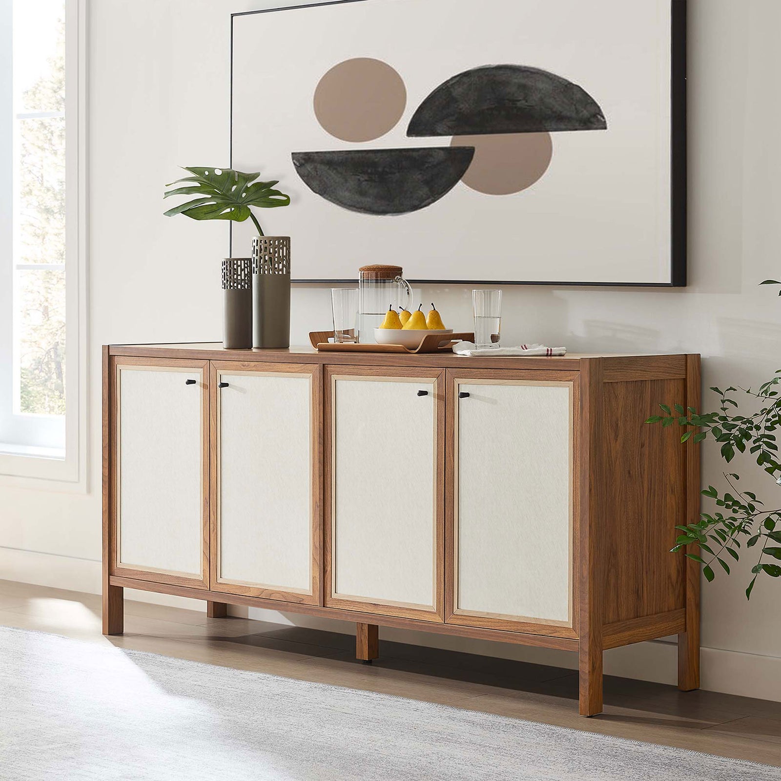 Walnut sideboard styled in a modern dining space with art, greenery, and serving accessories. || EEI-6616-WAL || front_angle_room