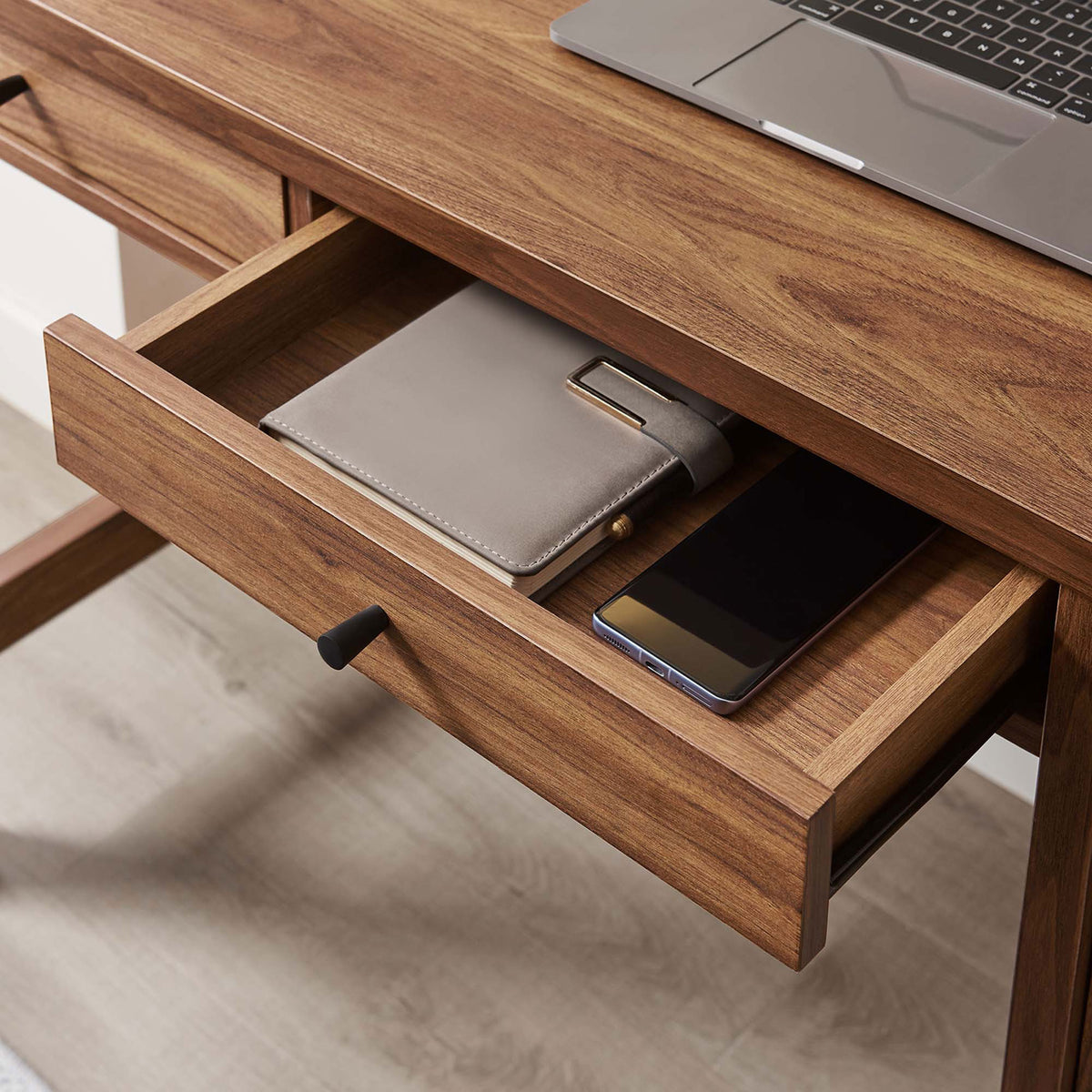 Drawer interior shown with everyday items, demonstrating smooth glides and tidy organization. || EEI-6617-WAL || storage_open_room