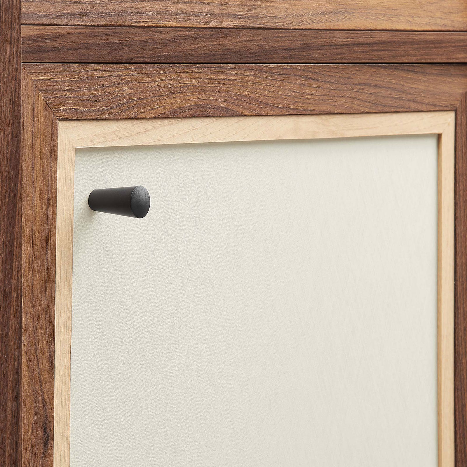 Matte black knob and linen-textured door framed in contrasting wood grain || EEI-6618-WAL || handle_studio