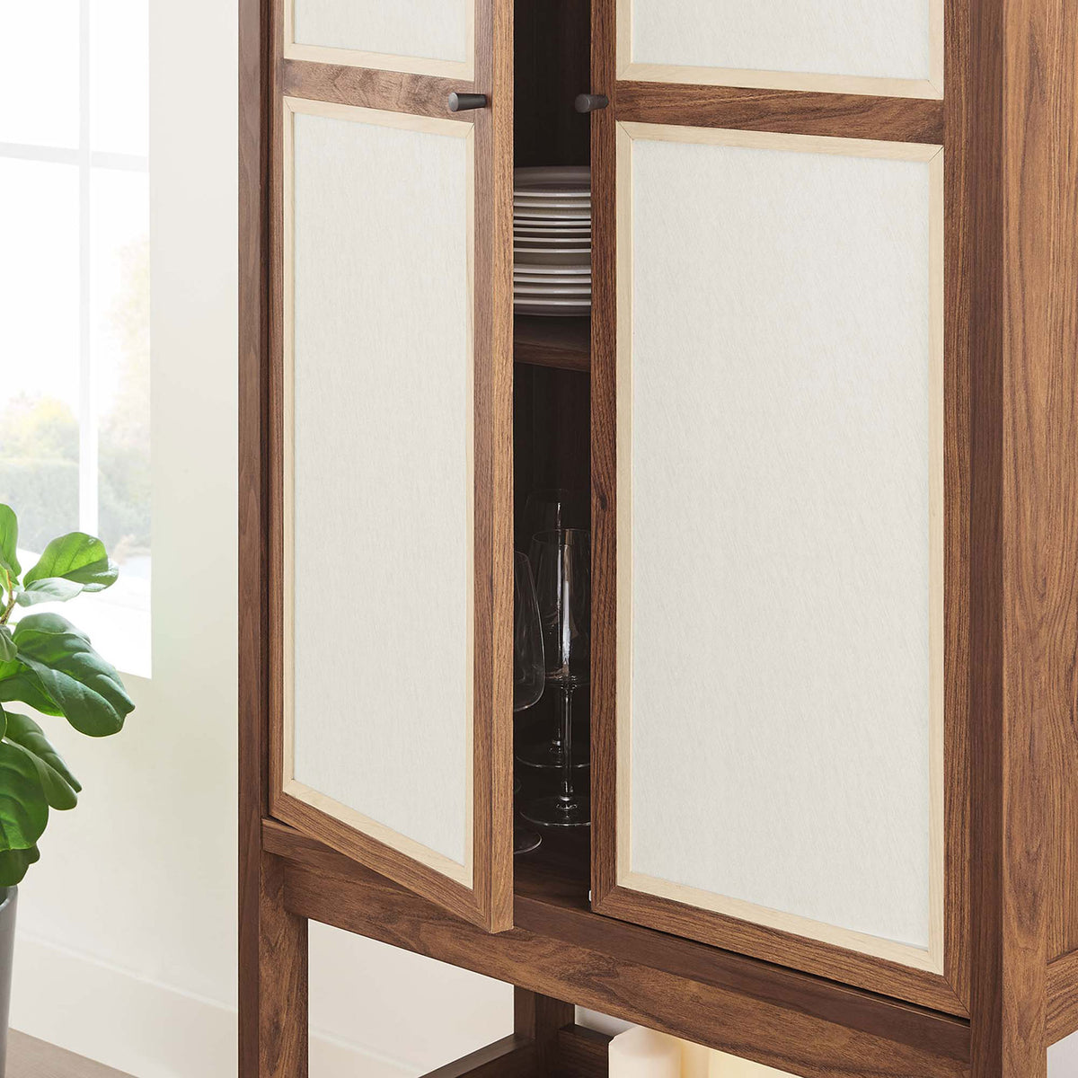 Cabinet shown in use with linen door partially open to reveal neatly organized dishes and glassware || EEI-6620-WAL || storage_open_room