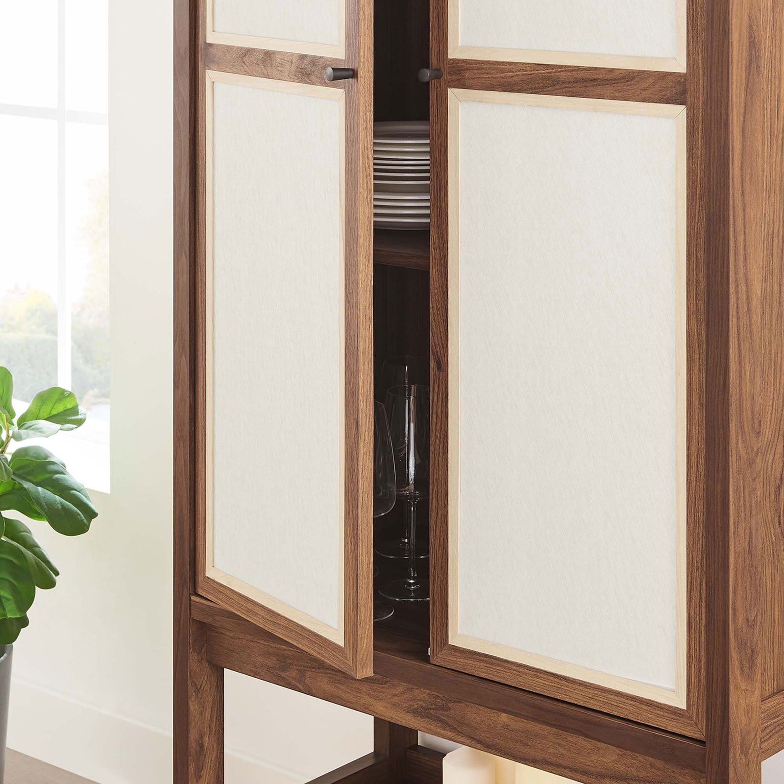 Cabinet shown in use with linen door partially open to reveal neatly organized dishes and glassware || EEI-6620-WAL || storage_open_room