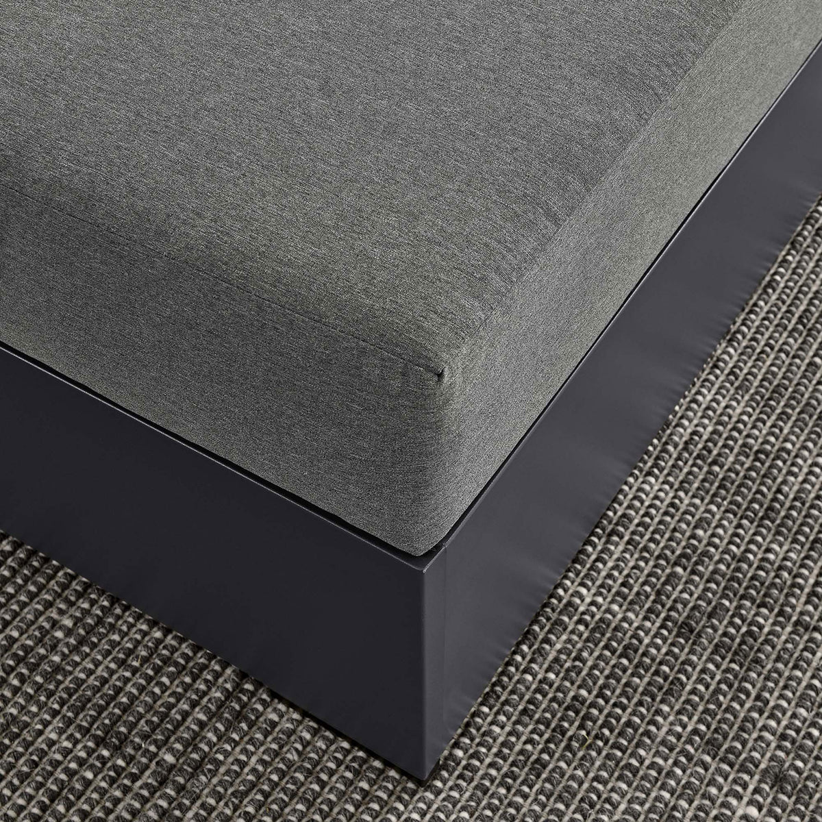 Textured outdoor rug and charcoal ottoman showcase the refined finish and tailored cushion edges || EEI-6627-GRY-CHA || detail_room