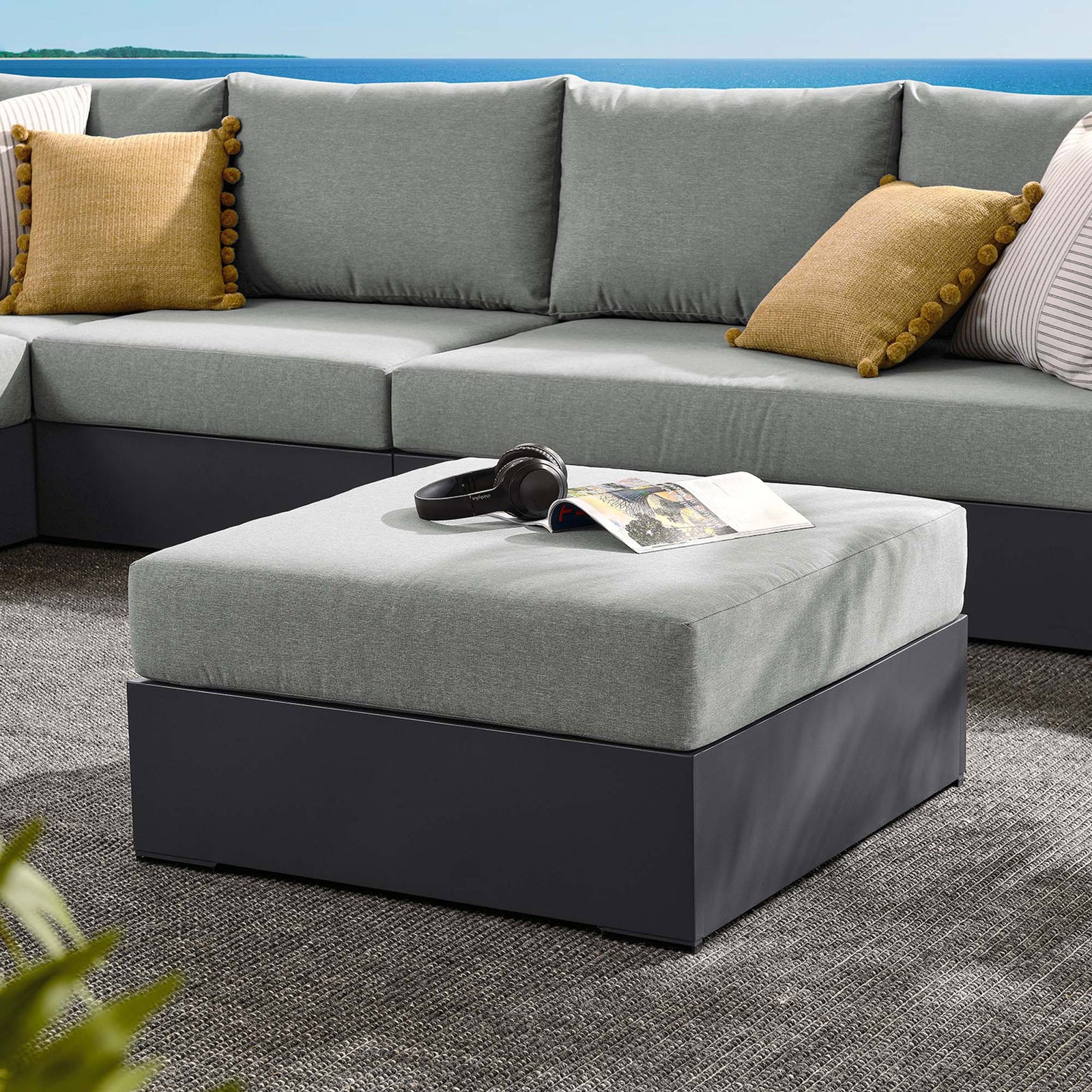 Tahoe gray ottoman centers a modular outdoor sectional, ready for serving or stretching out || EEI-6627-GRY-GRY || front_angle_room