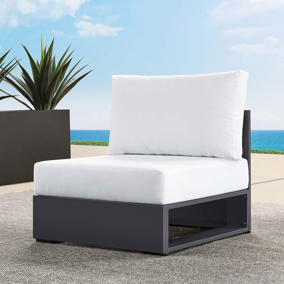 White Tahoe outdoor armless chair positioned on a poolside patio with ocean view and modern planter || EEI-6628-GRY-WHI || front_angle_room