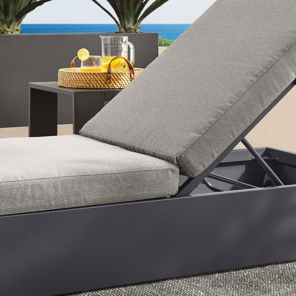 Light gray cushioned chaise on a balcony, emphasizing the layered cushions and sturdy metal frame || EEI-6634-GRY-GRY || detail_room