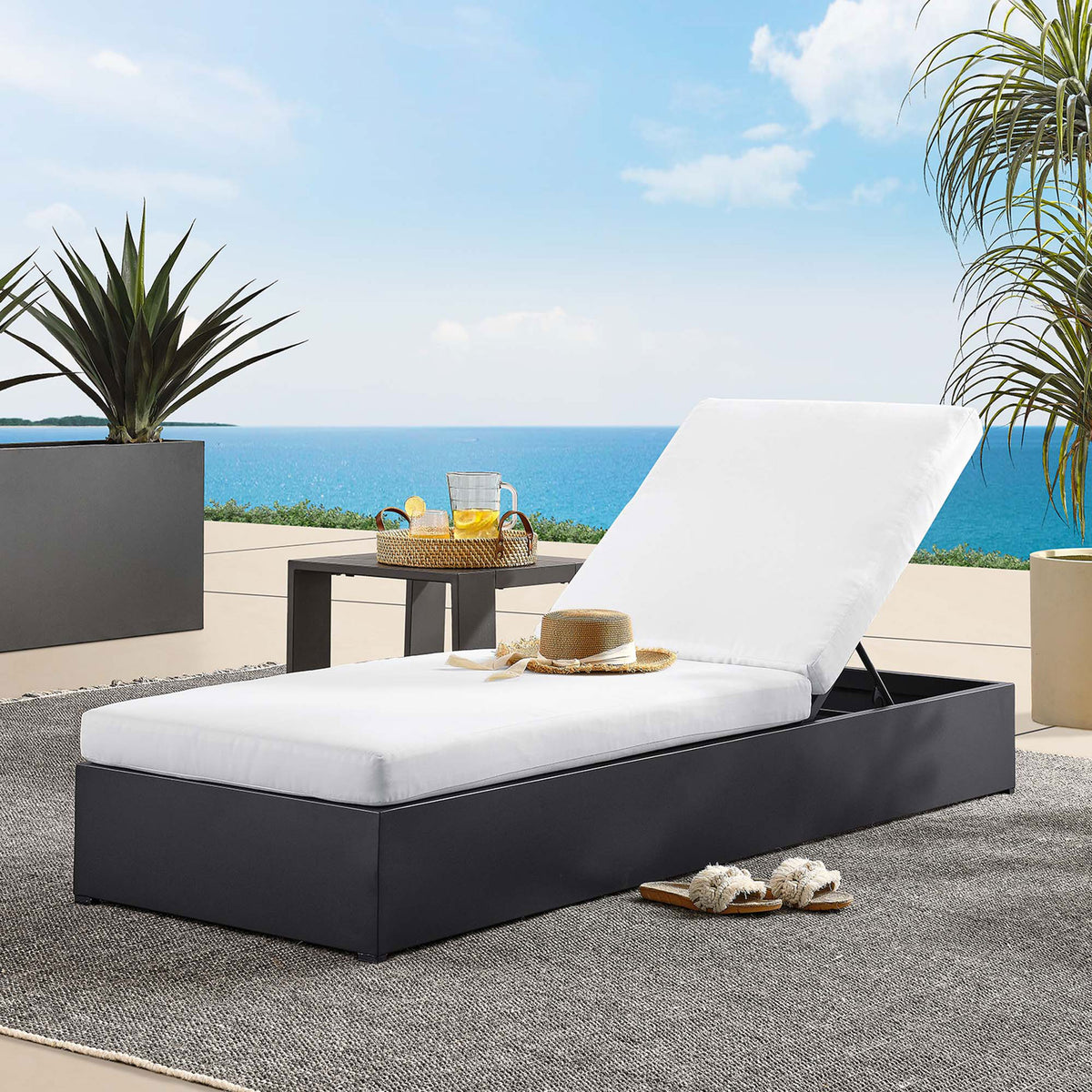 White chaise lounge styled by the pool with side table, drinks, and accessories for coastal relaxation || EEI-6634-GRY-WHI || front_angle_room