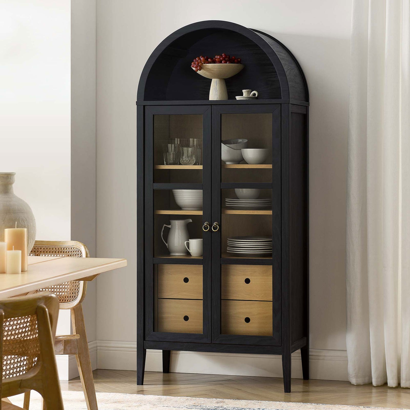 Black oak arched cabinet styled in a modern dining room with ceramics and glassware displayed || EEI-6639-BLK-OAK || front_angle_room
