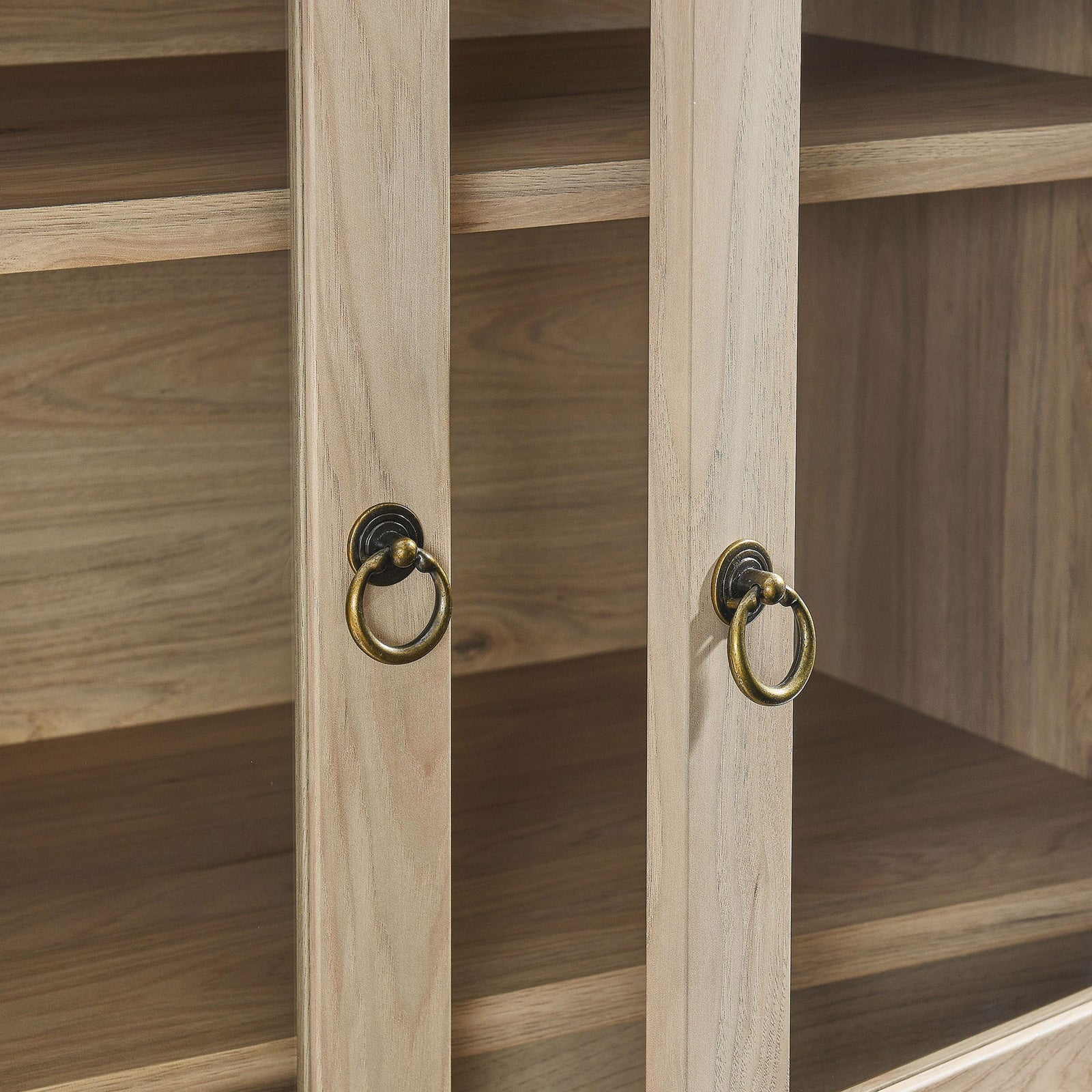 Antique brass ring pulls contrast with the light oak frame of the glass cabinet doors || EEI-6639-LOA || handle_studio
