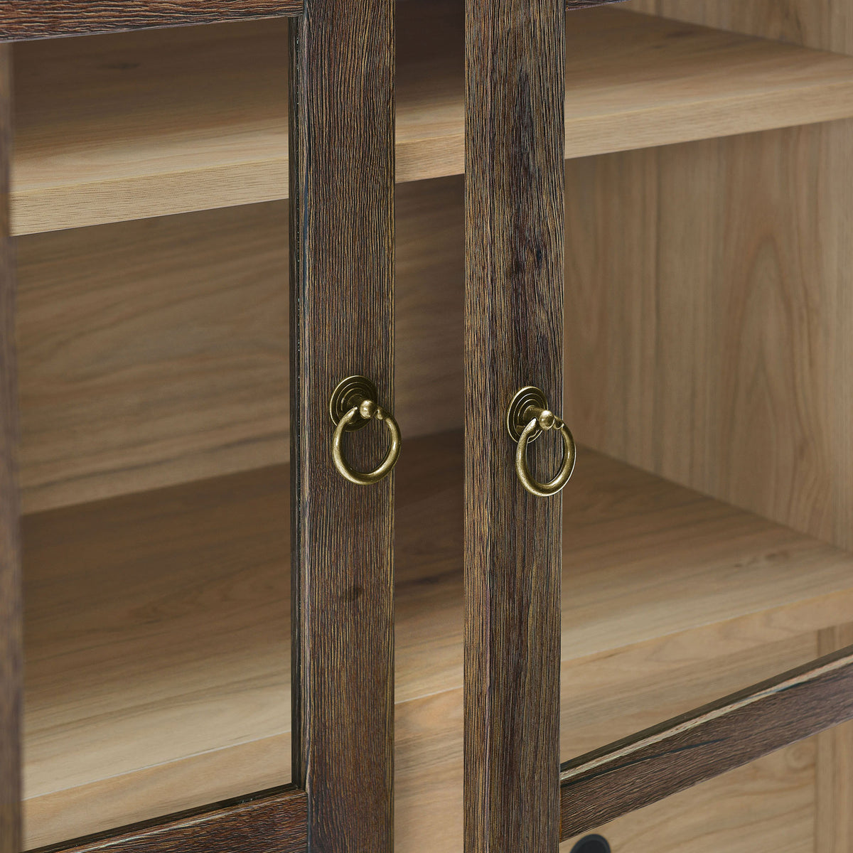 Brushed gold ring pulls accent the warm walnut hickory frame of the cabinet doors || EEI-6639-WAL-HCK || handle_studio