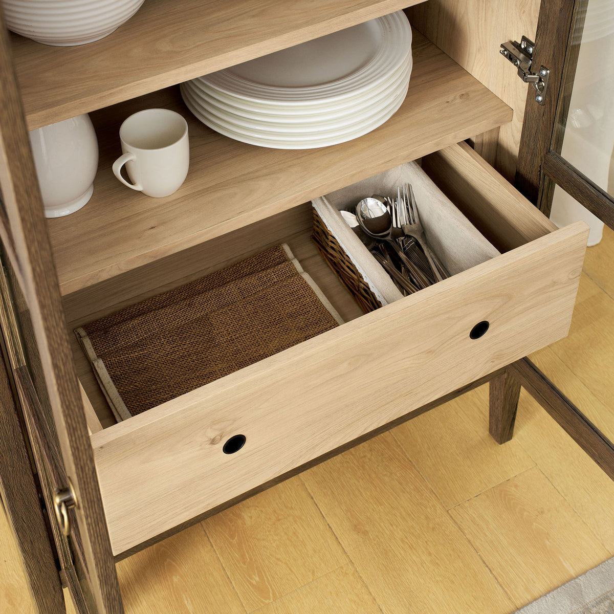 Lower drawer of the walnut hickory cabinet organizing cutlery, napkins, and small accessories || EEI-6639-WAL-HCK || storage_open_room