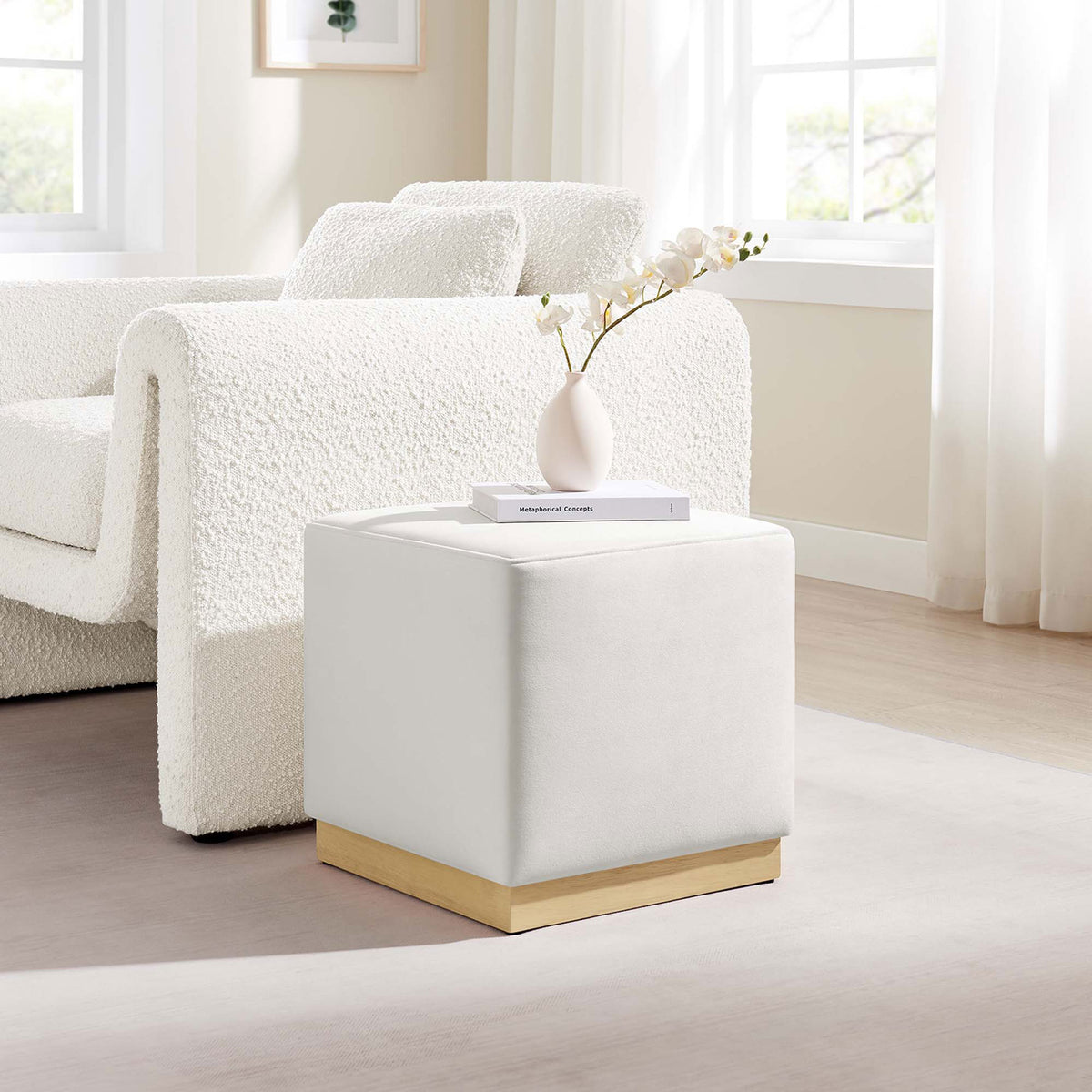 Alabaster velvet ottoman adds a soft modern accent beside a cozy boucle sofa in a bright living room. || EEI-6640-ALA-NAT || front_angle_room