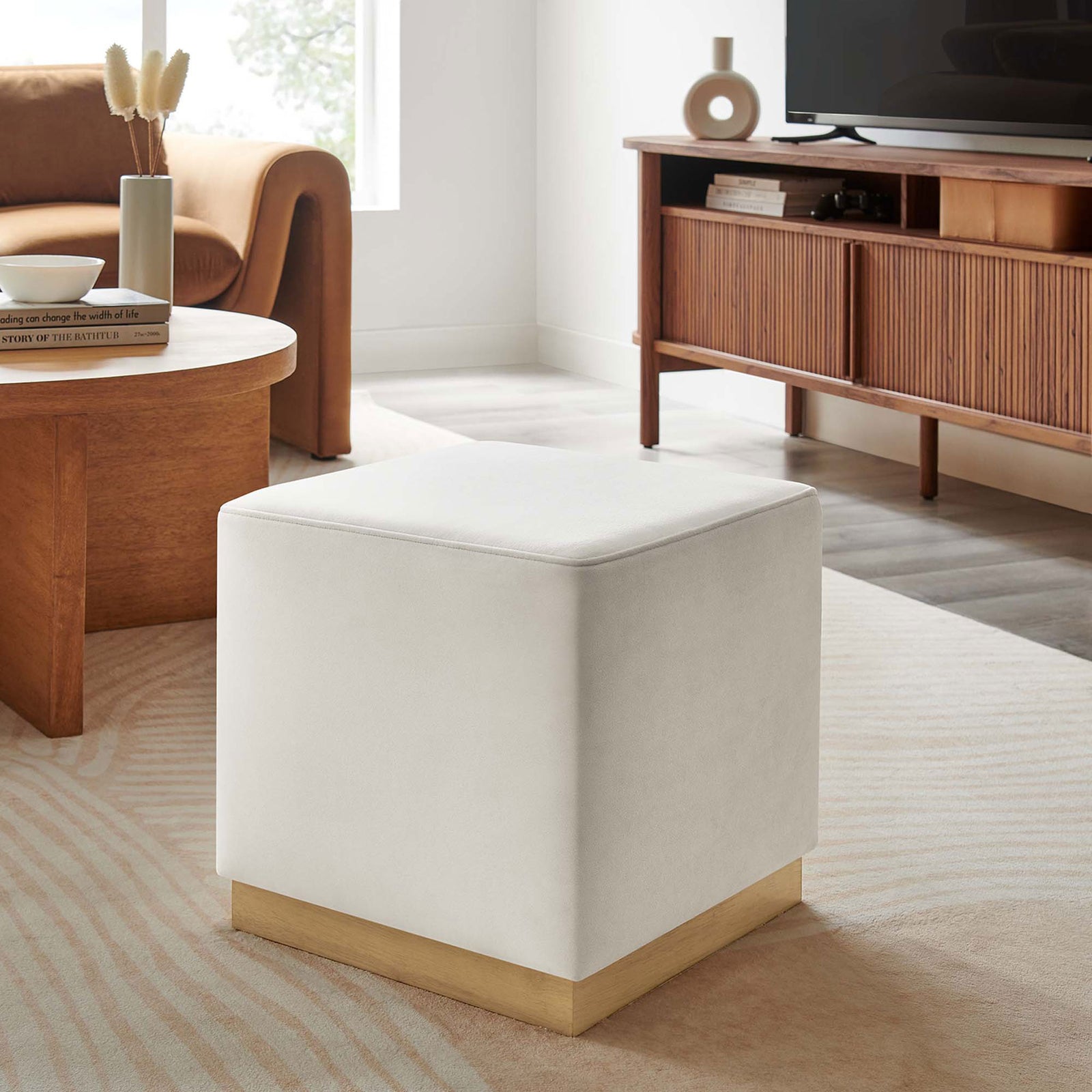 Alabaster velvet ottoman pairs with warm wood furniture to complete a modern neutral living room. || EEI-6640-ALA-NAT || front_angle_room