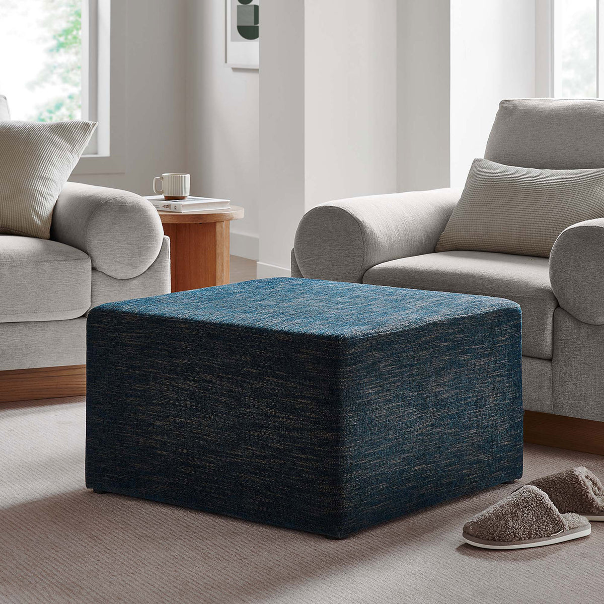 Cozy seating vignette features the ottoman as a plush footrest beside a modern armchair. || EEI-6642-HEA || front_angle_room
