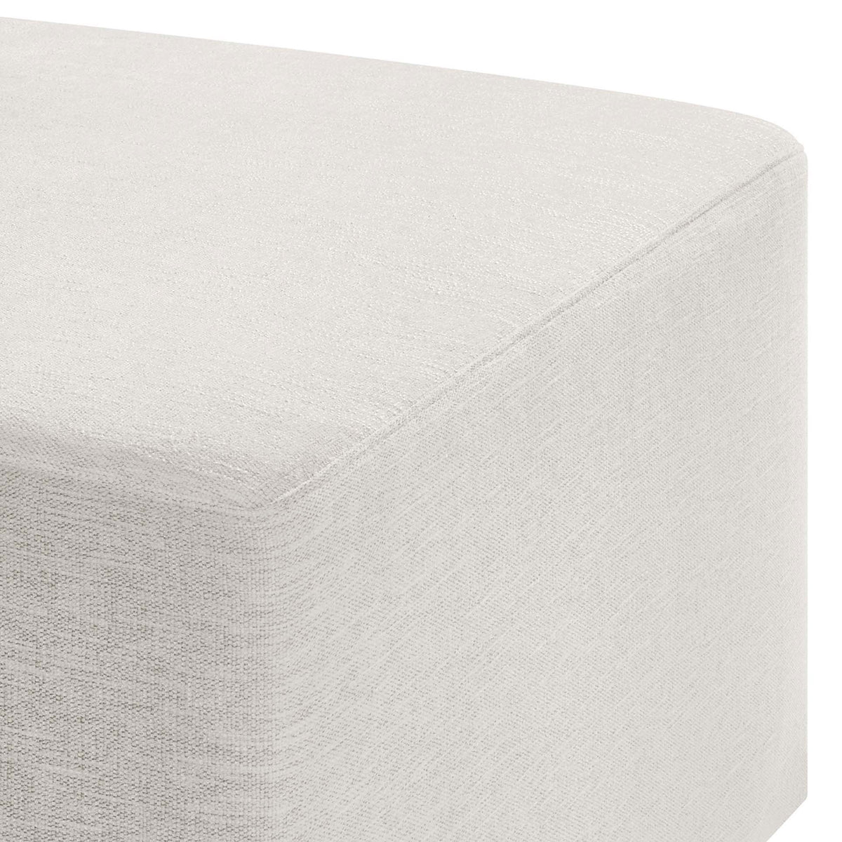 Heathered ivory fabric and smooth padding highlight the ottoman's softly rounded corner || EEI-6642-HEI || detail_studio