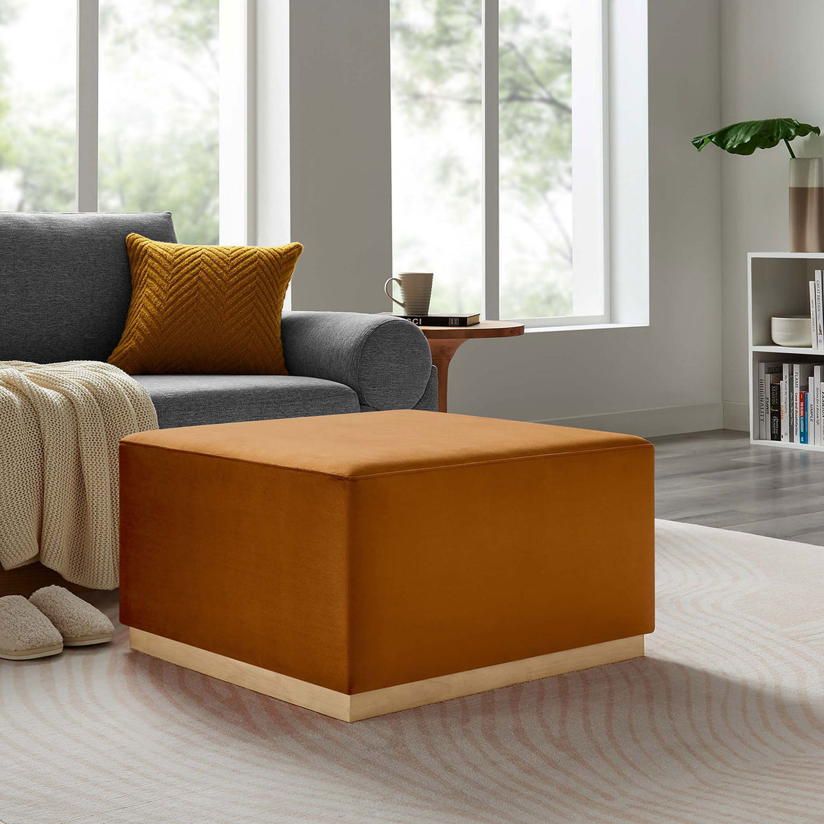 Rust velvet ottoman complements gray sofa, knit throw, and matching accent pillow in cozy room || EEI-6643-RUS-NAT || front_angle_room