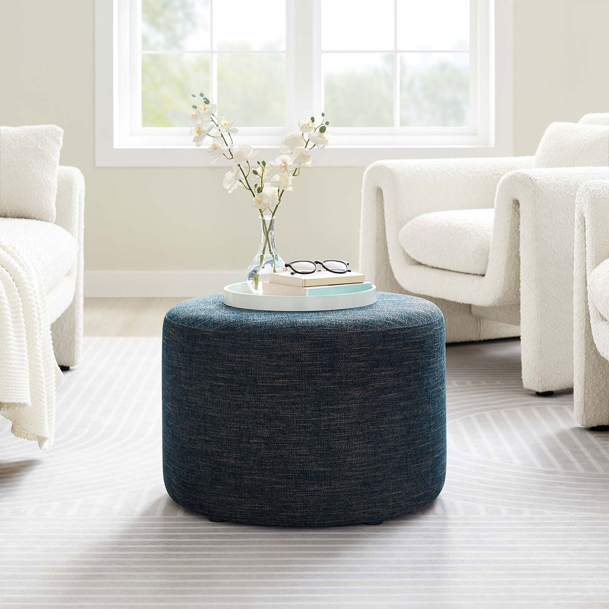 Blue heathered ottoman centers a bright living room as a stylish perch for trays, books, and decor || EEI-6645-HEA || front_angle_room