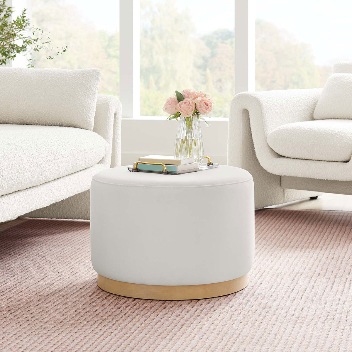 Alabaster round ottoman adds a soft accent to an airy modern living room with a textured blush rug. || EEI-6646-ALA-NAT || front_room