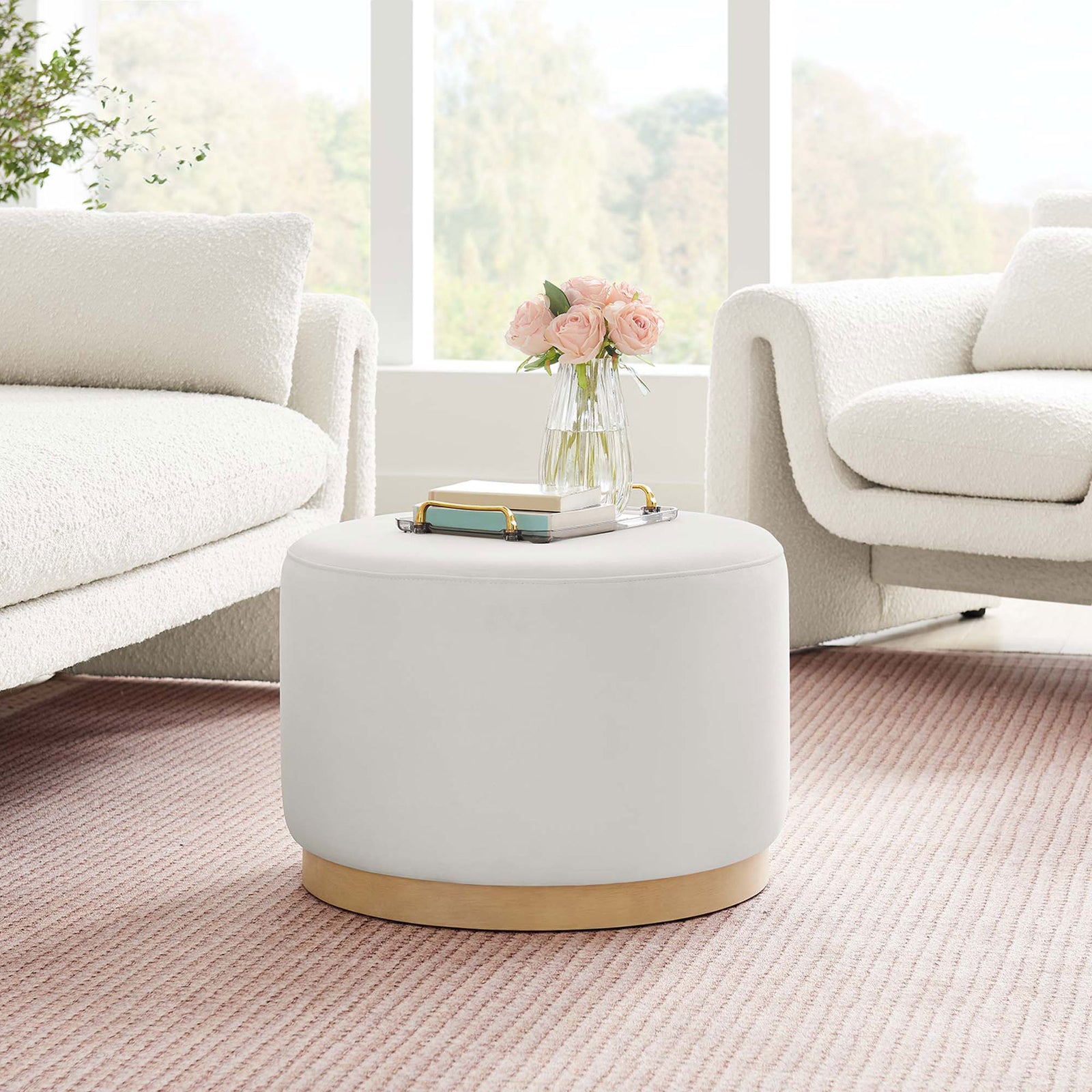 Alabaster round ottoman adds a soft accent to an airy modern living room with a textured blush rug. || EEI-6646-ALA-NAT || front_room