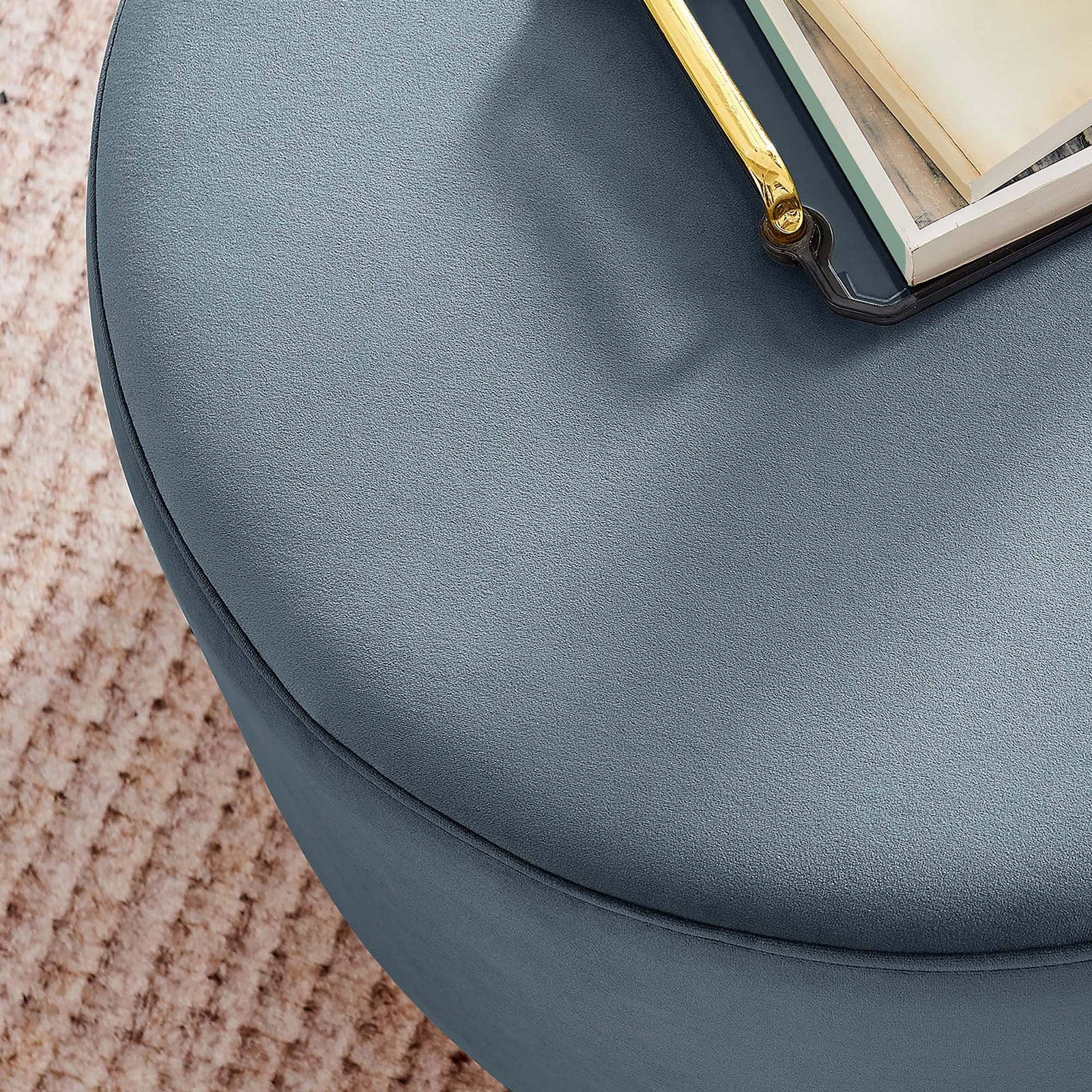 Blue velvet ottoman styled with a tray and book, adding a soft textured accent to a cozy living room || EEI-6646-CAB-NAT || detail_room