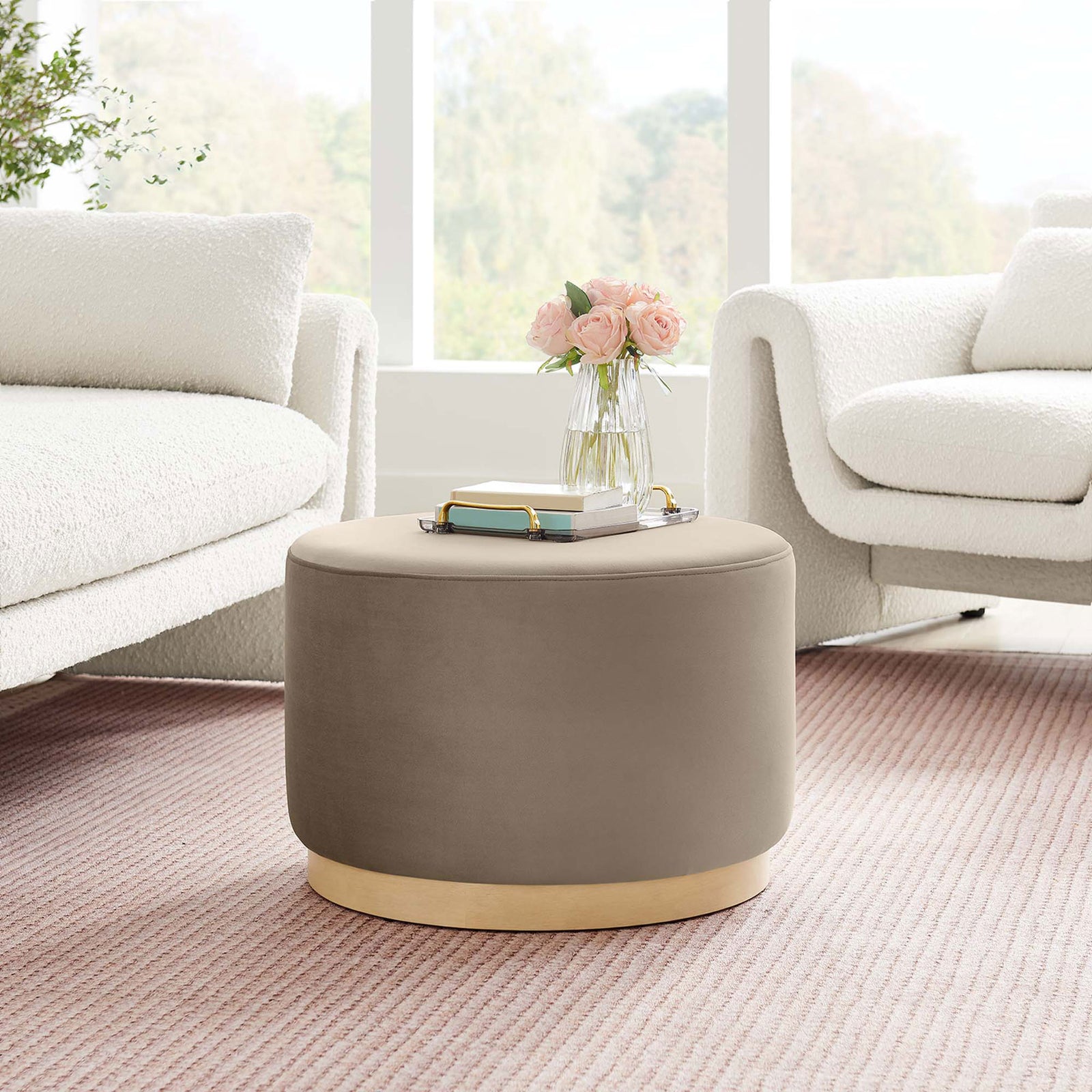 Taupe velvet round ottoman on a blush rug between two boucle chairs in a bright airy living room || EEI-6646-TAU-NAT || front_angle_room