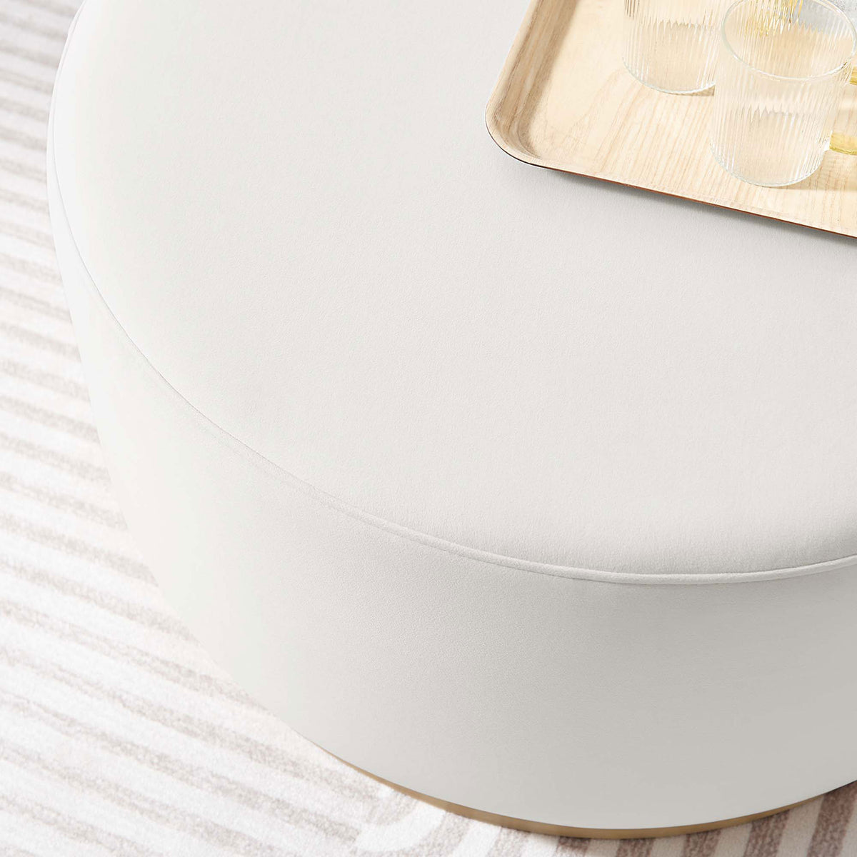Alabaster velvet Tilden ottoman styled with a tray on a striped rug in a bright modern living room || EEI-6648-ALA-NAT || detail_room
