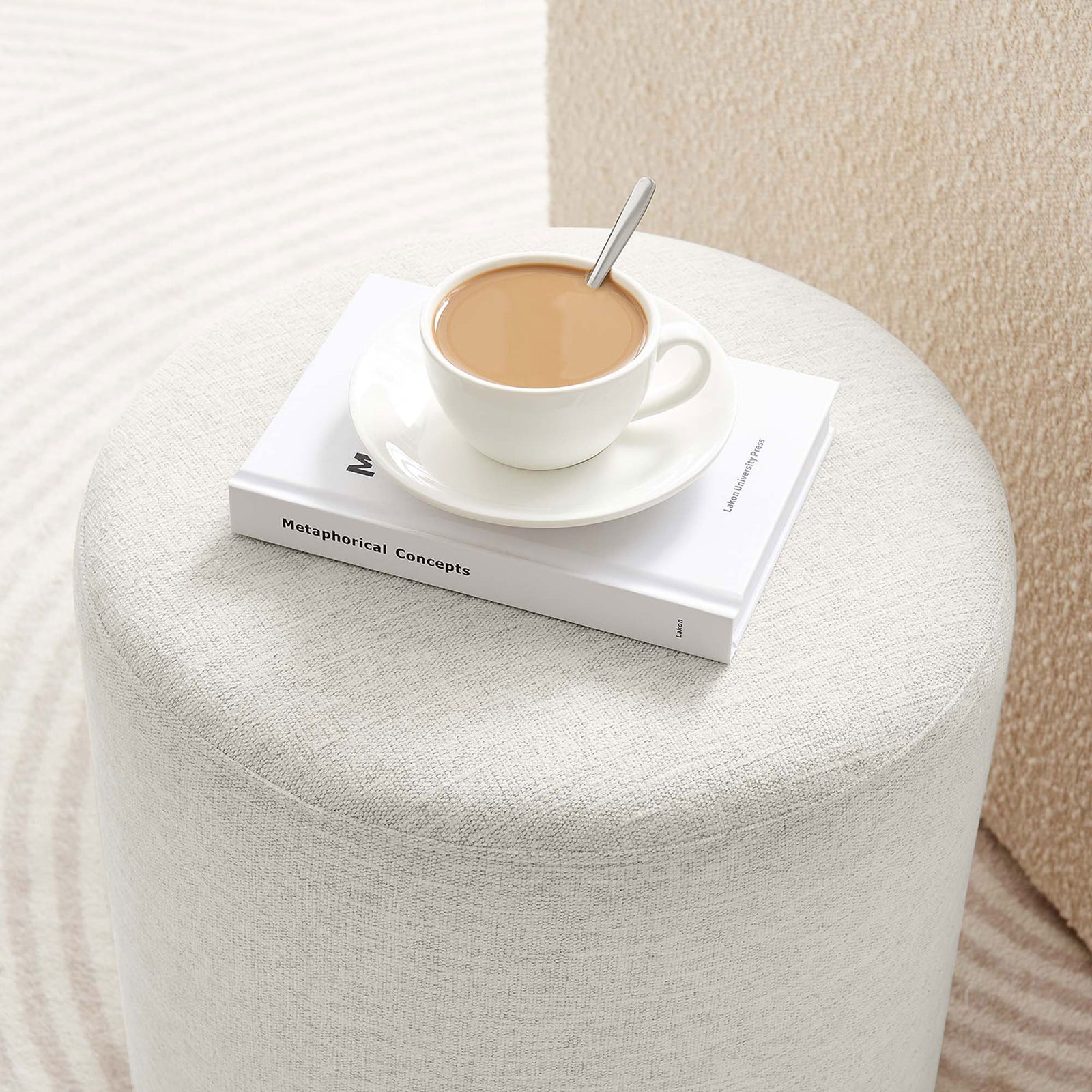 Ottoman serves as a petite ivory perch for your coffee and book, adding cozy function to modern decor. || EEI-6651-HEI || detail_room