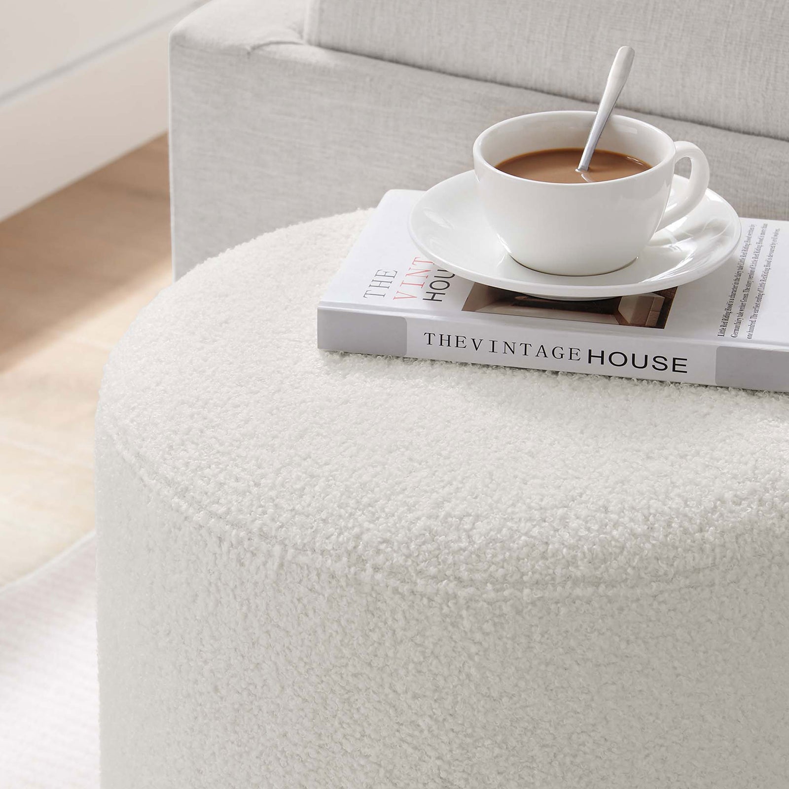 Ivory sherpa ottoman doubles as a handy side table for coffee and books in a relaxed living space || EEI-6653-IVO-NAT || detail_room