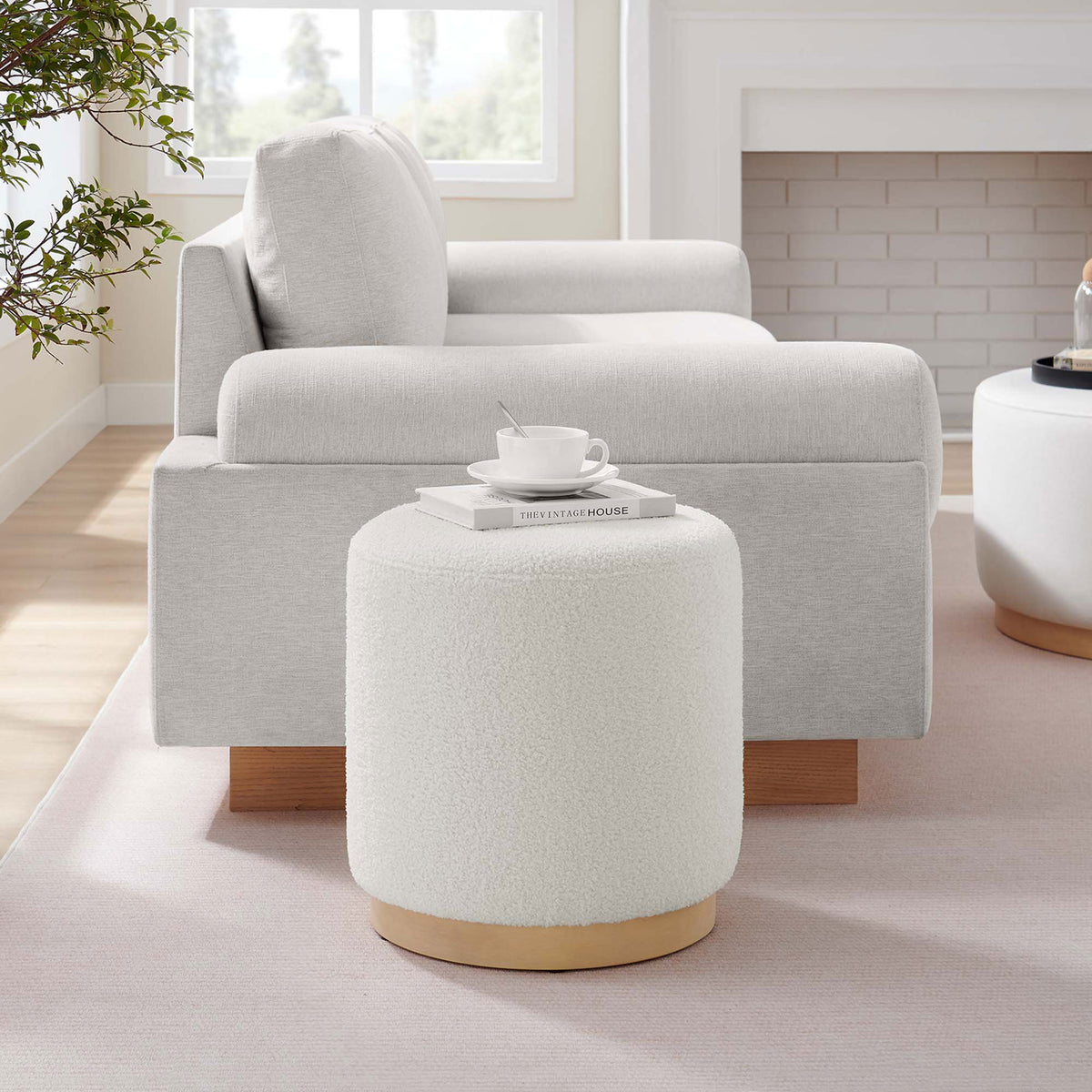 Ivory sherpa ottoman adds soft texture and extra seating beside a modern neutral sofa || EEI-6653-IVO-NAT || front_angle_room