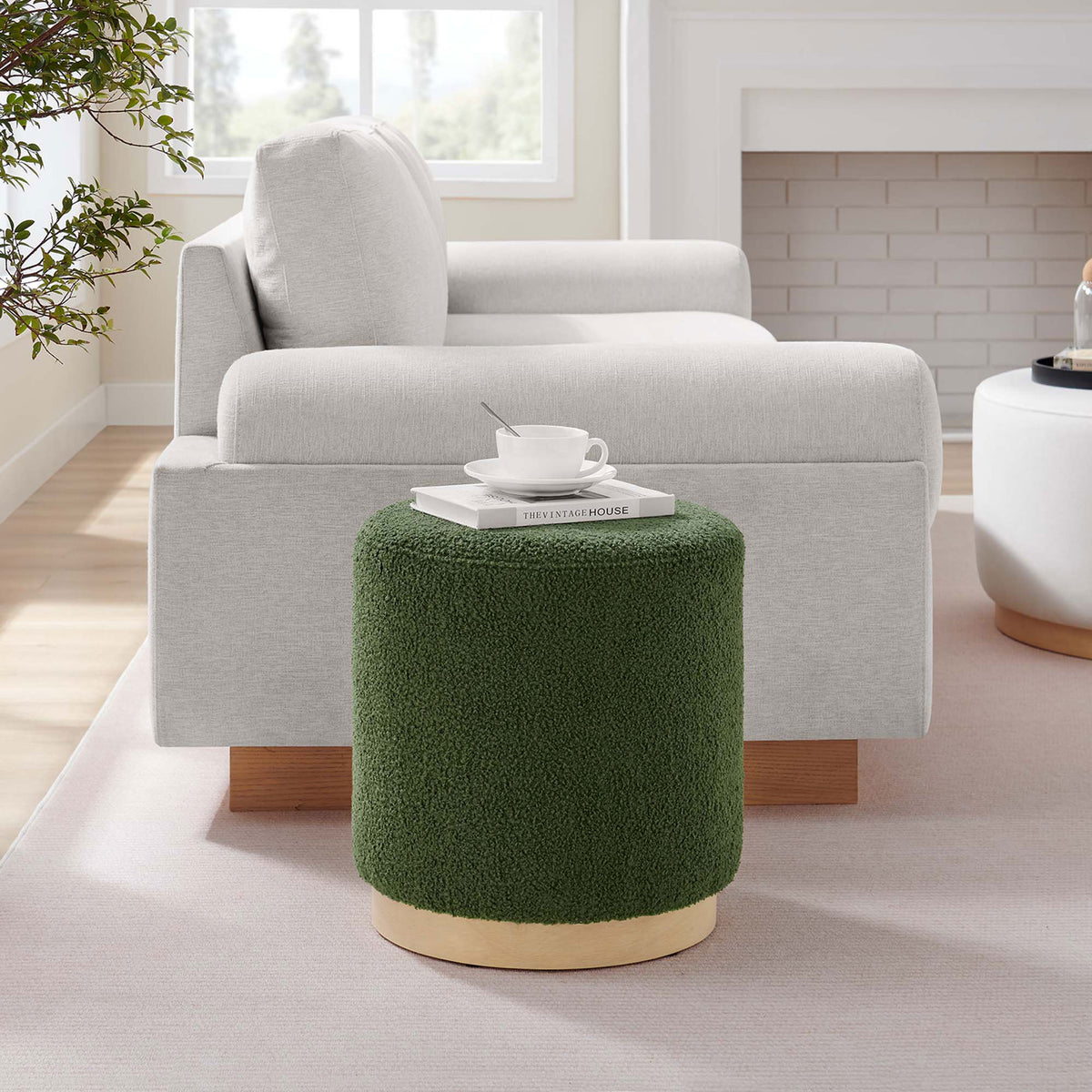 Moss green sherpa ottoman styled beside a sofa as a modern accent table in a bright living room || EEI-6653-MOG-NAT || front_room