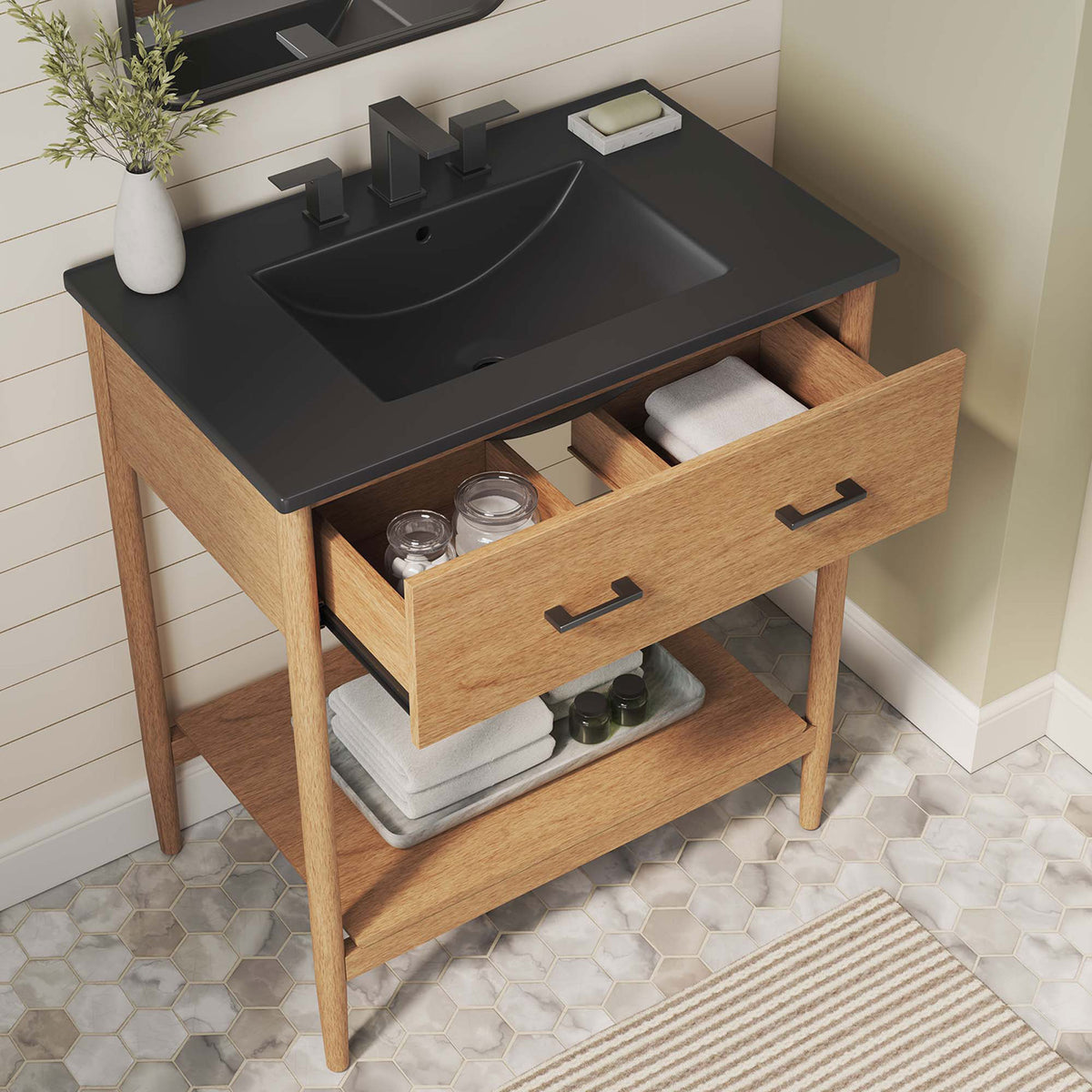 Open drawer reveals organized storage with black basin and warm wood tones in a bright bath || EEI-6663-NAT-BLK || top_angle_open_room