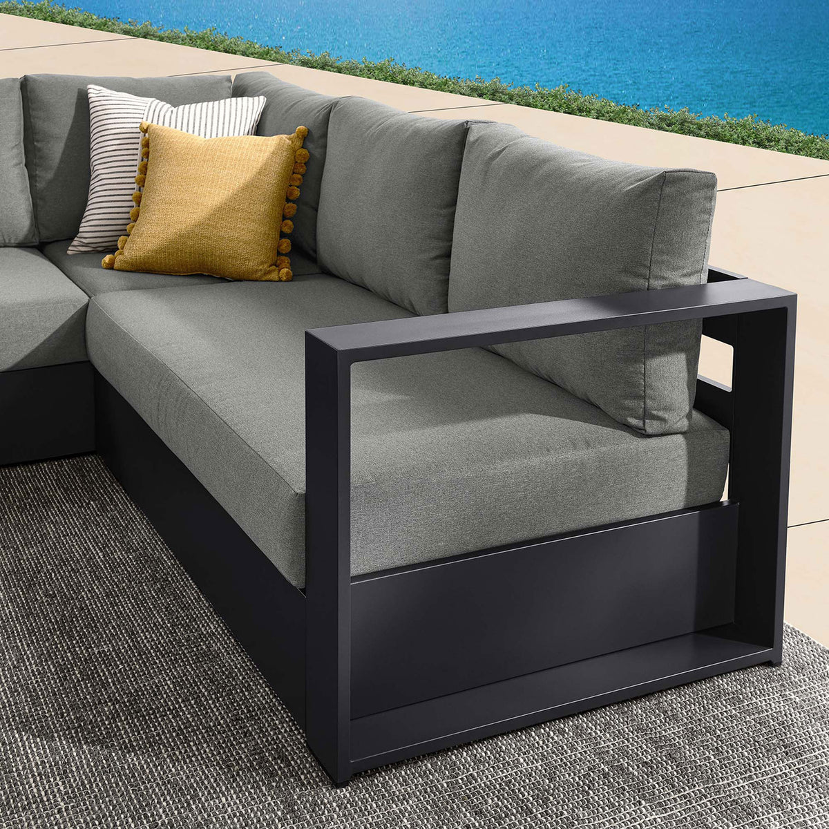 Charcoal armrest detail highlights the sectionals wide open-frame arm design and tailored outdoor cushions || EEI-6668-GRY-CHA || detail_room