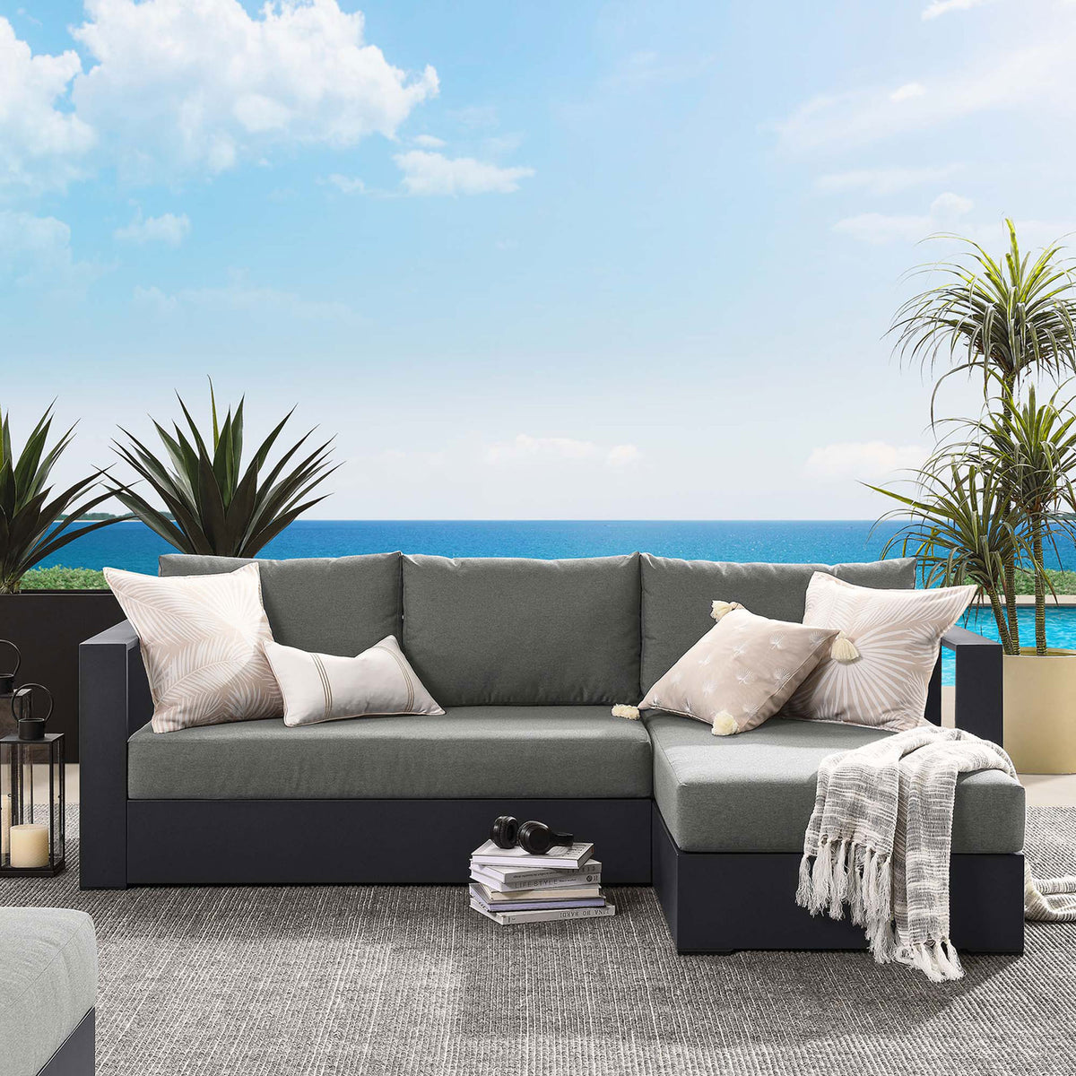 Right-chaise Tahoe sectional arranged on a sunny patio with neutral pillows and cozy throws || EEI-6669-GRY-CHA || front_angle_room