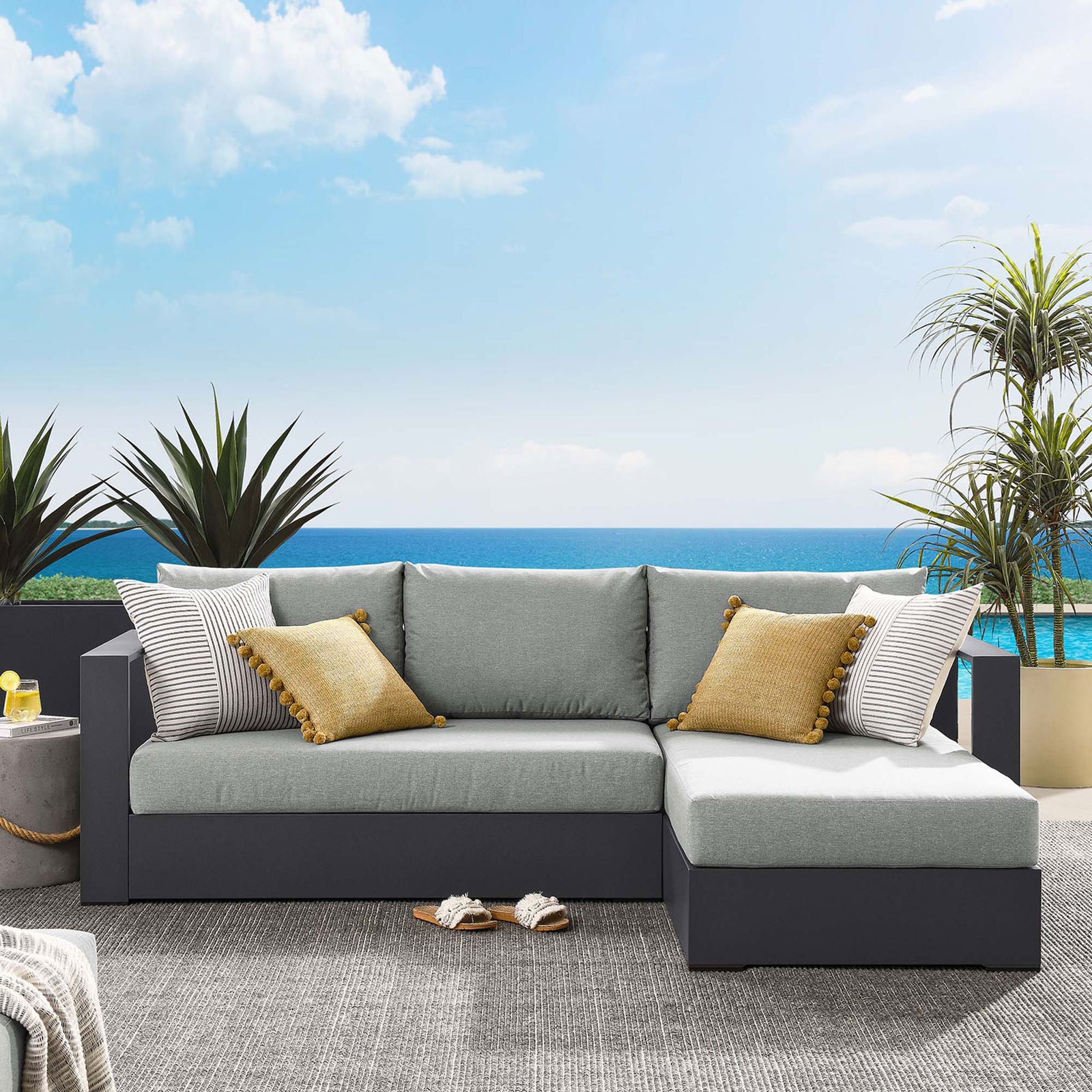 Right-chaise Tahoe sectional with light gray cushions arranged by the water with cozy accents || EEI-6669-GRY-GRY || front_angle_room