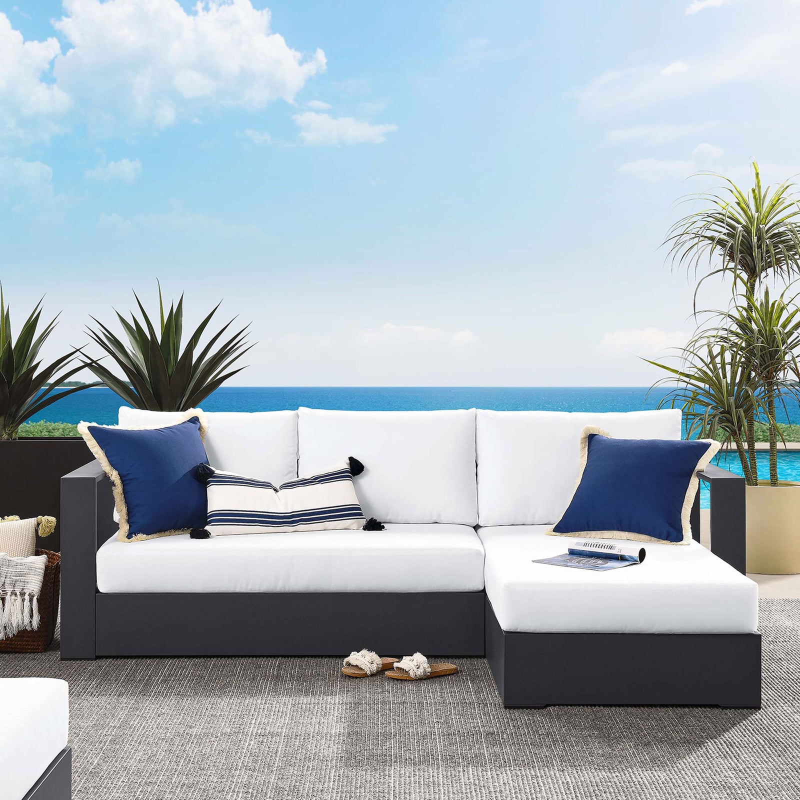 Right-chaise Tahoe sectional with white cushions arranged by the pool with nautical pillows || EEI-6669-GRY-WHI || front_angle_room