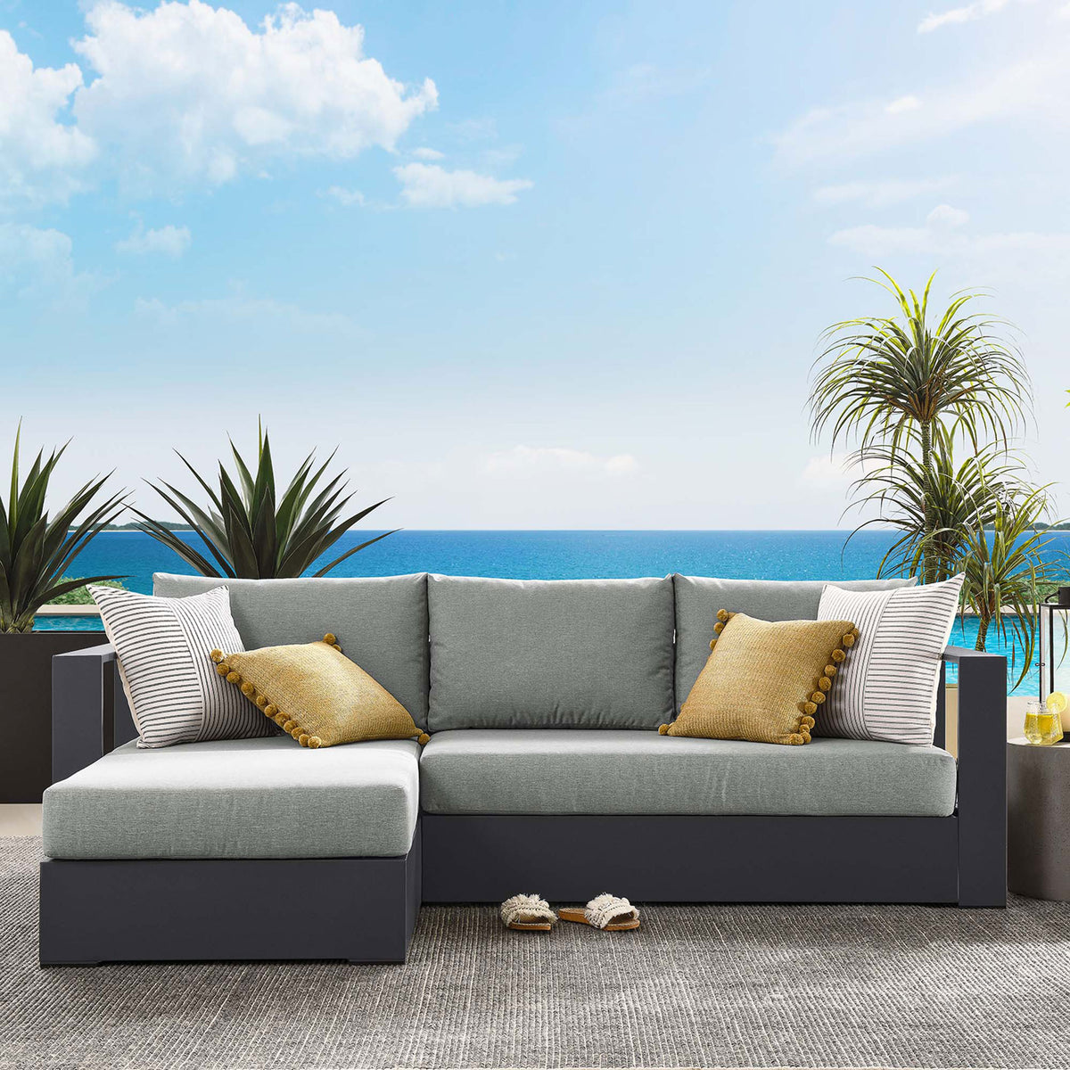 Left-chaise Tahoe sectional with light gray cushions styled by the pool with layered pillows || EEI-6670-GRY-GRY || front_angle_room