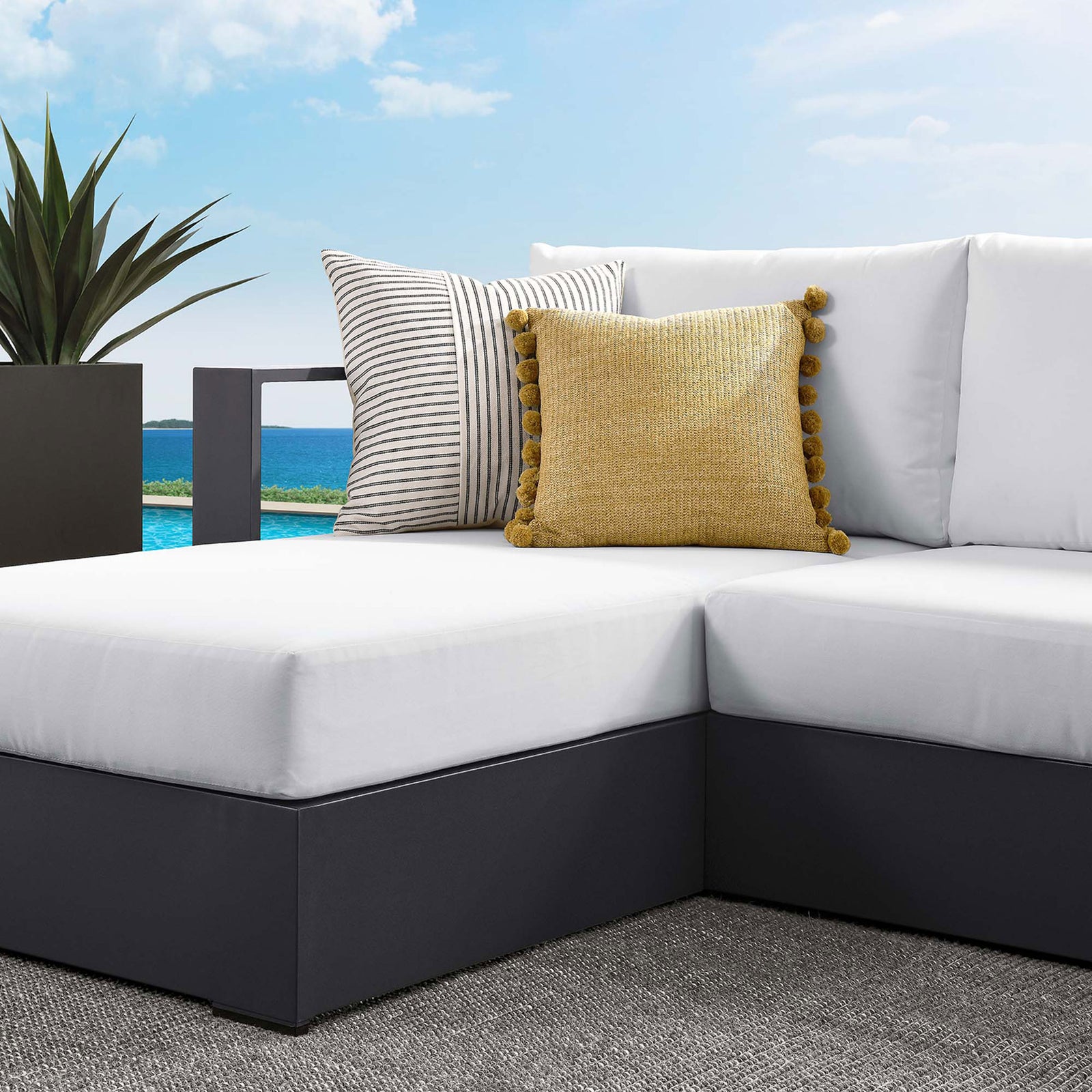 White cushions and contrasting pillows create a fresh, resort-style look on the Tahoe sectional || EEI-6670-GRY-WHI || detail_room