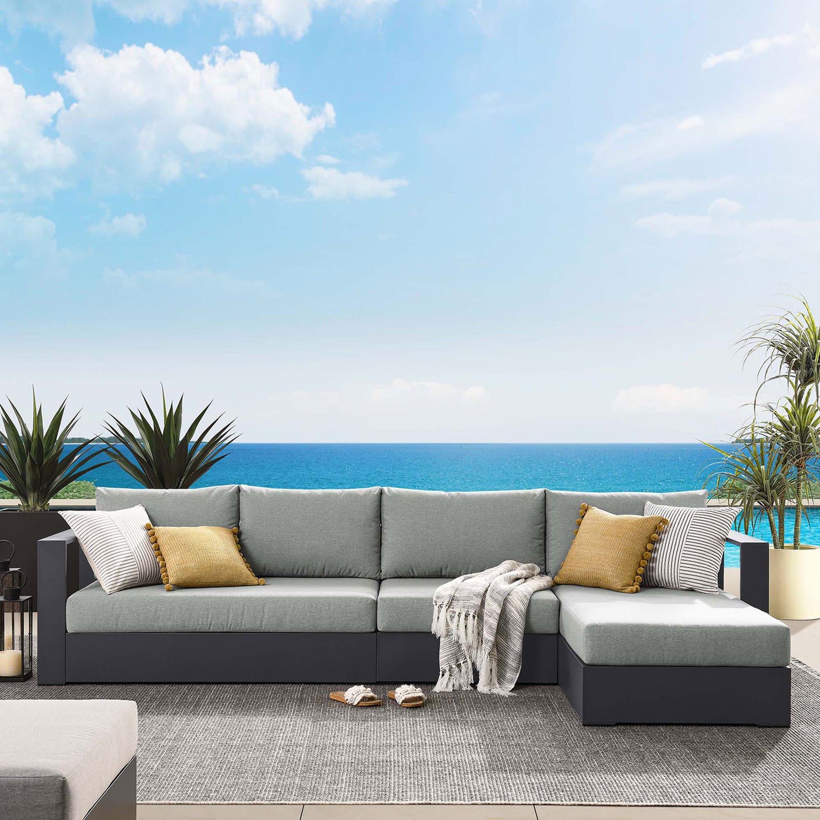 Gray sectional corner layered with striped and mustard pillows for a relaxed coastal outdoor look || EEI-6671-GRY-GRY || detail_room