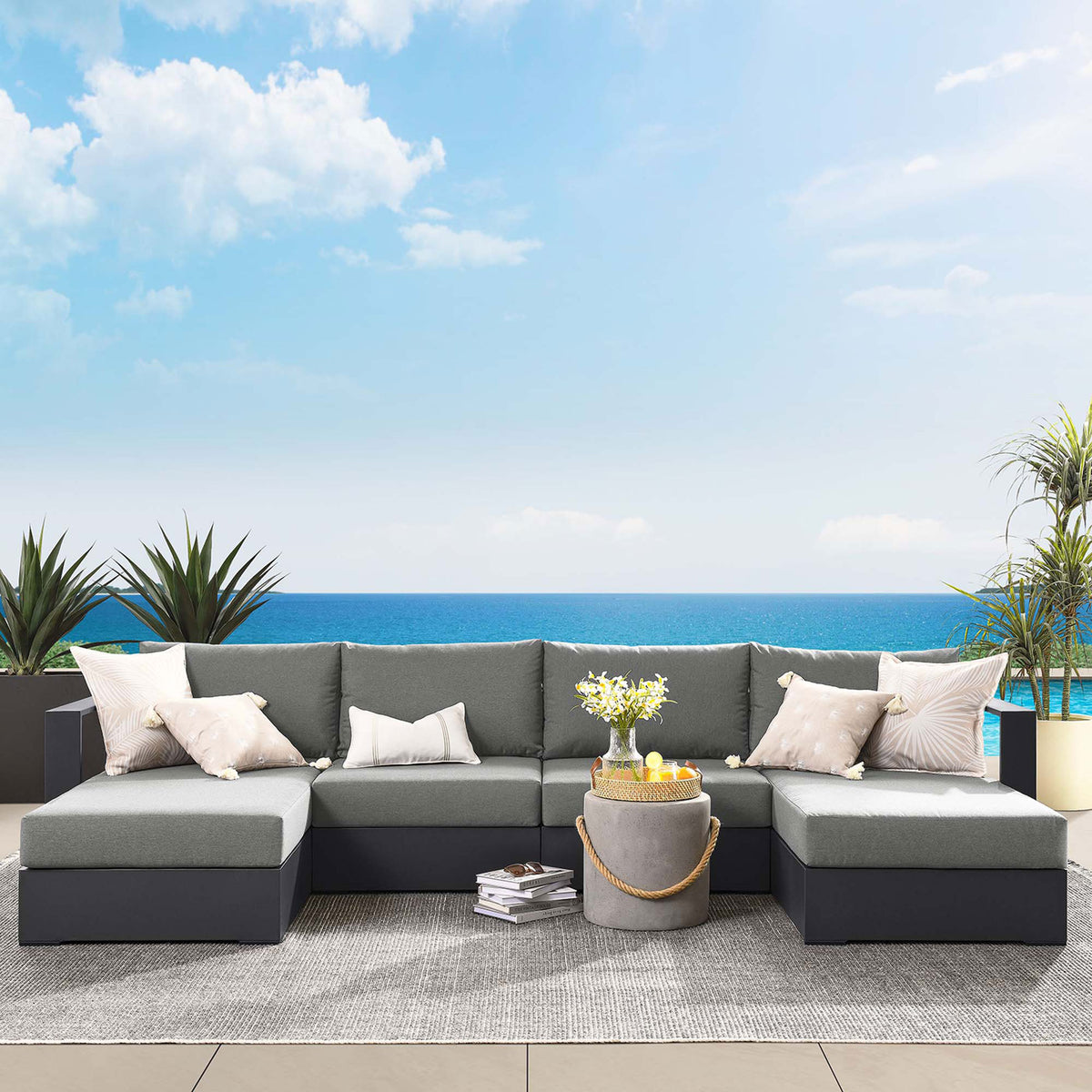 Tahoe outdoor sectional styled with pillows beside an oceanfront pool for relaxed all-weather entertaining || EEI-6676-GRY-CHA || front_angle_room