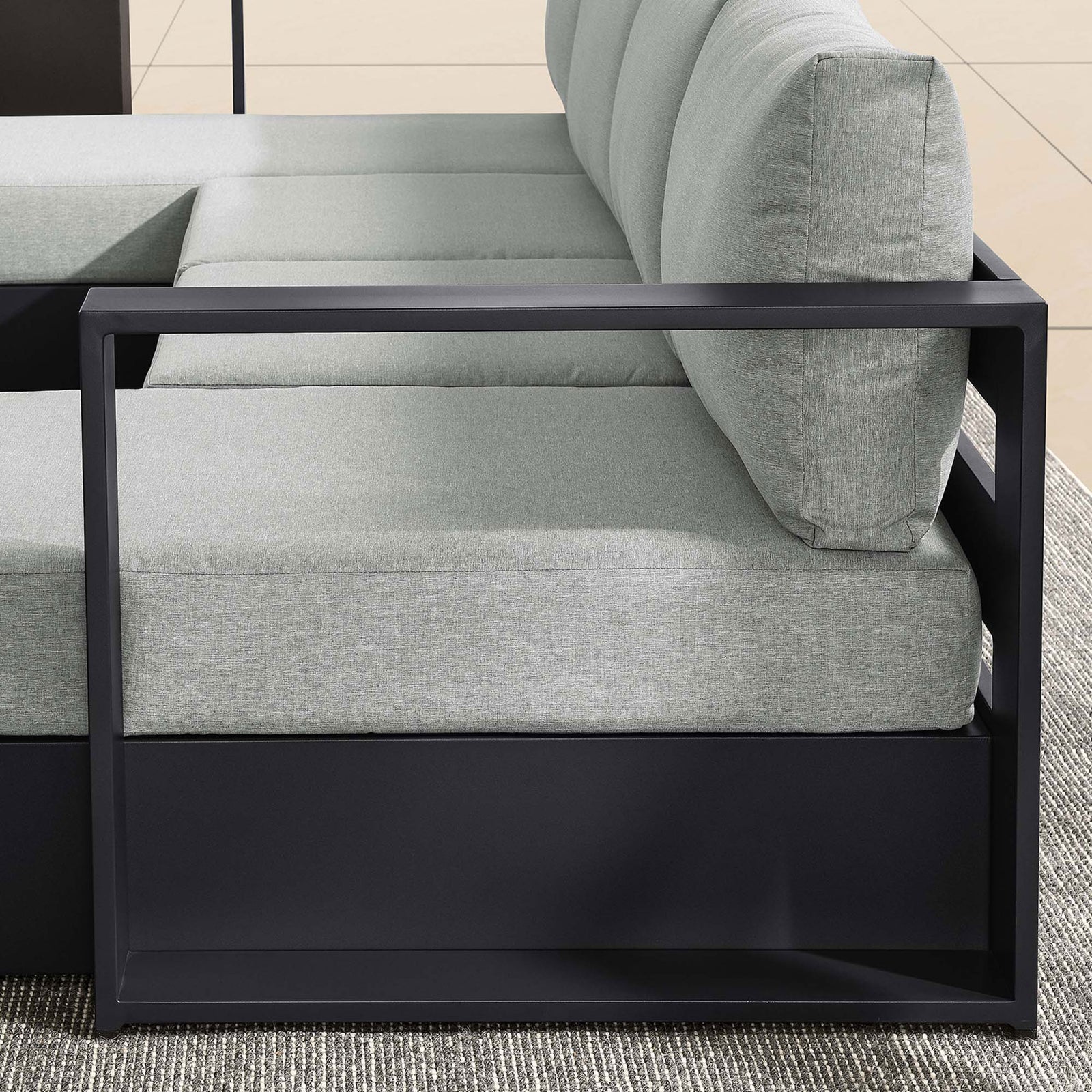 Linear metal arm and soft gray cushions creating a sleek architectural look on the Tahoe outdoor sectional || EEI-6676-GRY-GRY || detail_room