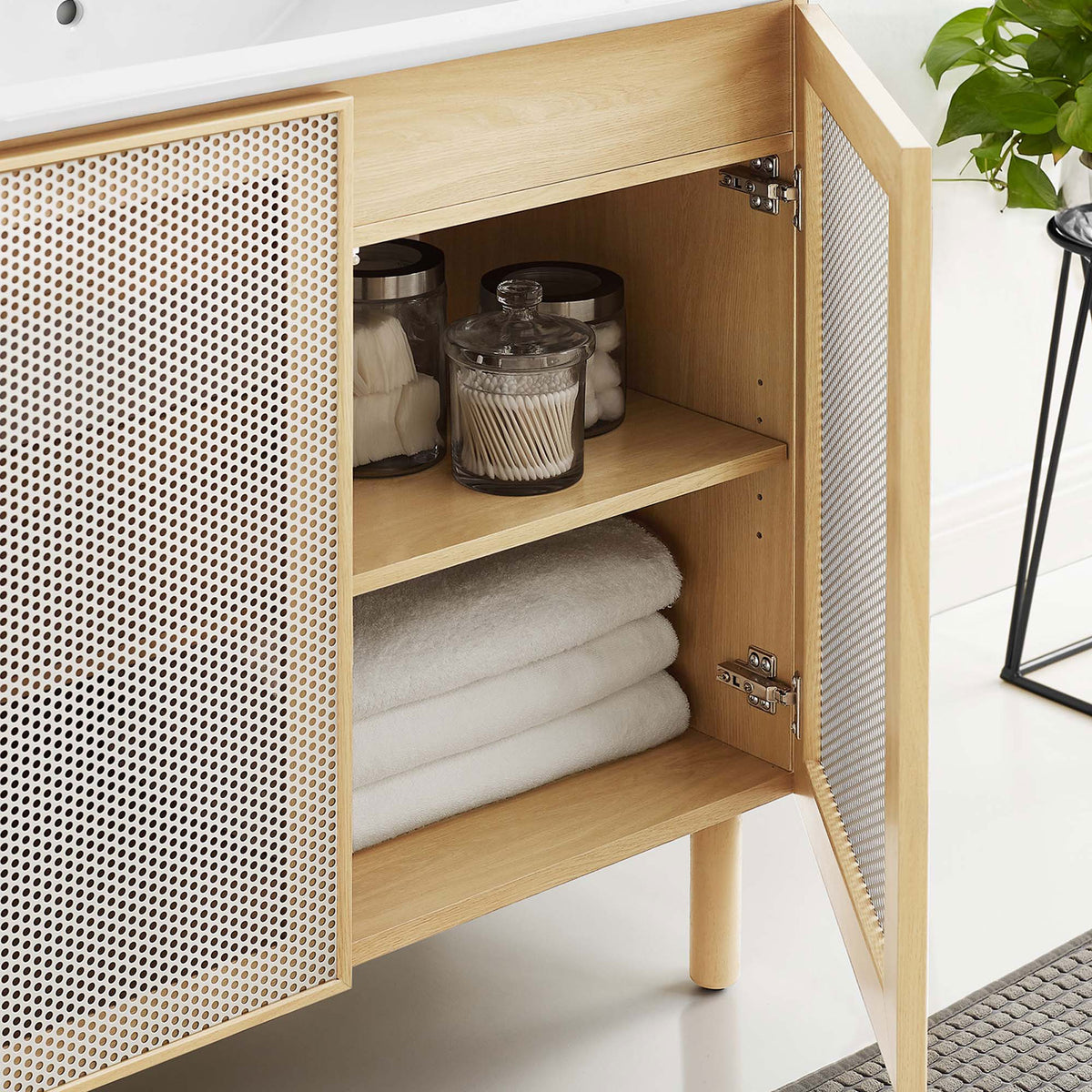 Interior storage with adjustable shelf neatly holds bathroom essentials behind the doors. || EEI-6678-WHI-OAK || storage_open_room