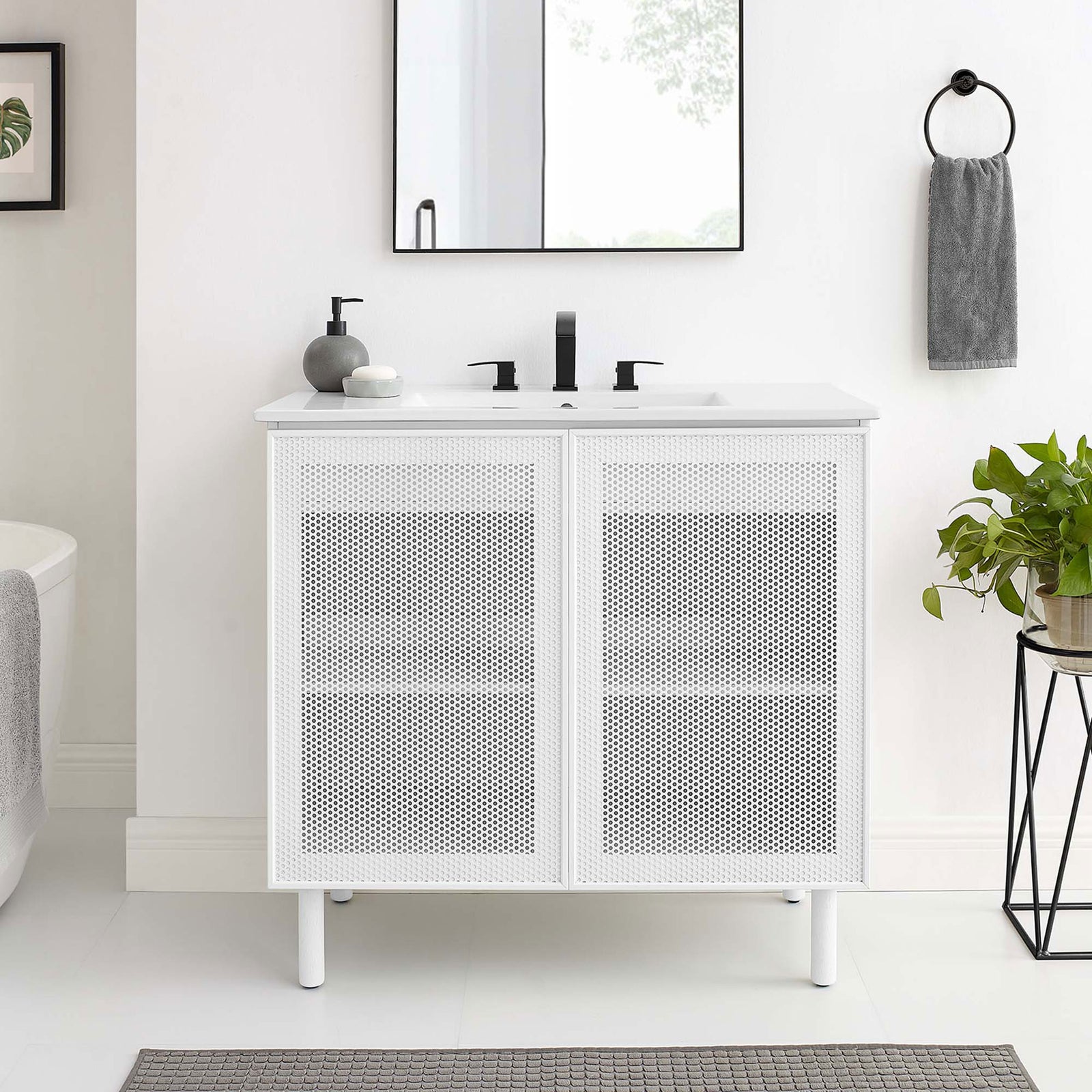 Sleek white vanity refreshes the bath with clean lines and perforated door detail || EEI-6678-WHI-WHI || front_room